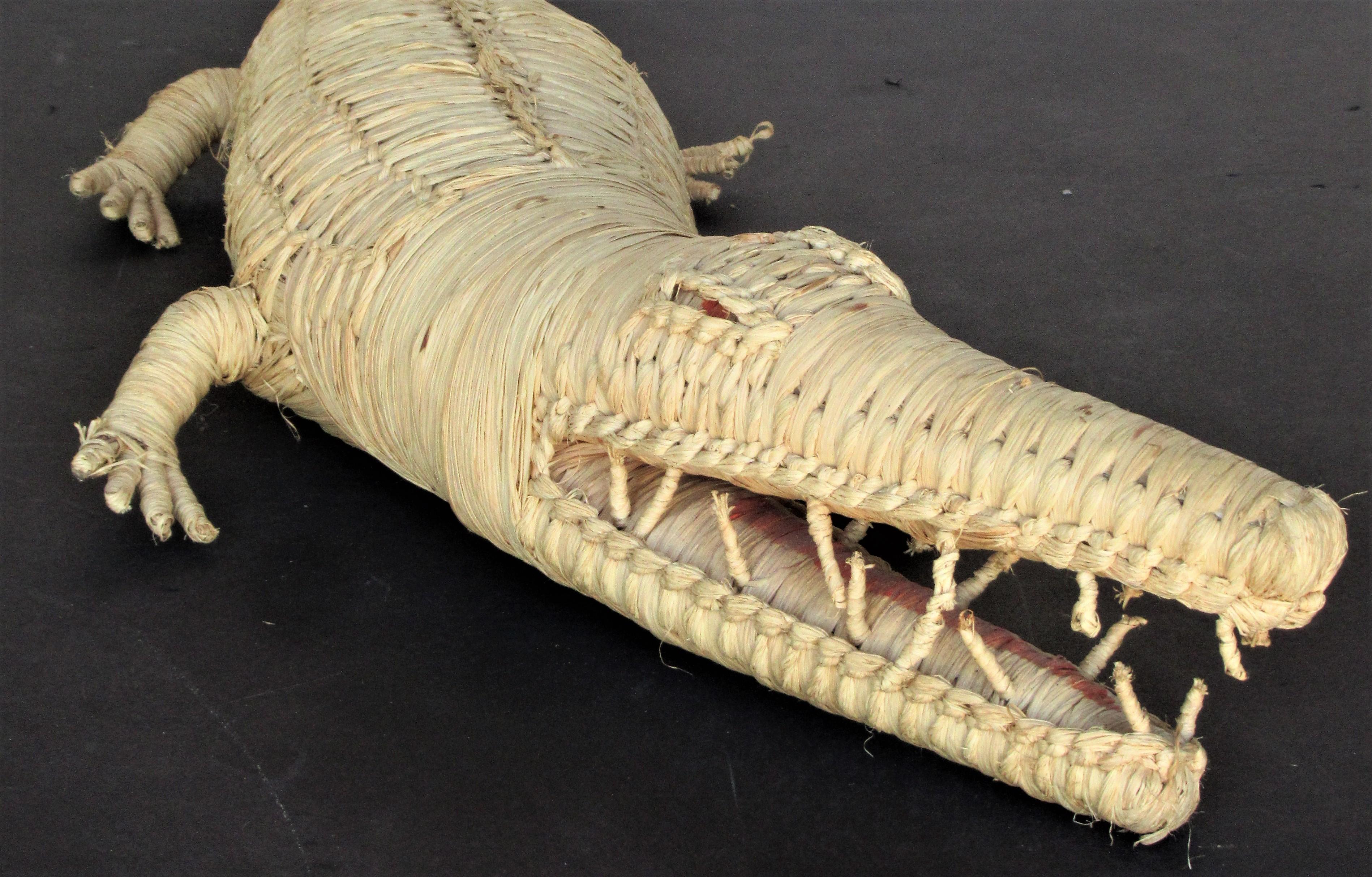 Large woven wicker raffia alligator or crocodile in the manner of Mario Lopez Torres. Ink stamped twice on underside belly but cannot read what it says (image 13) we think this dates from the late 20th century and is Central or South America in