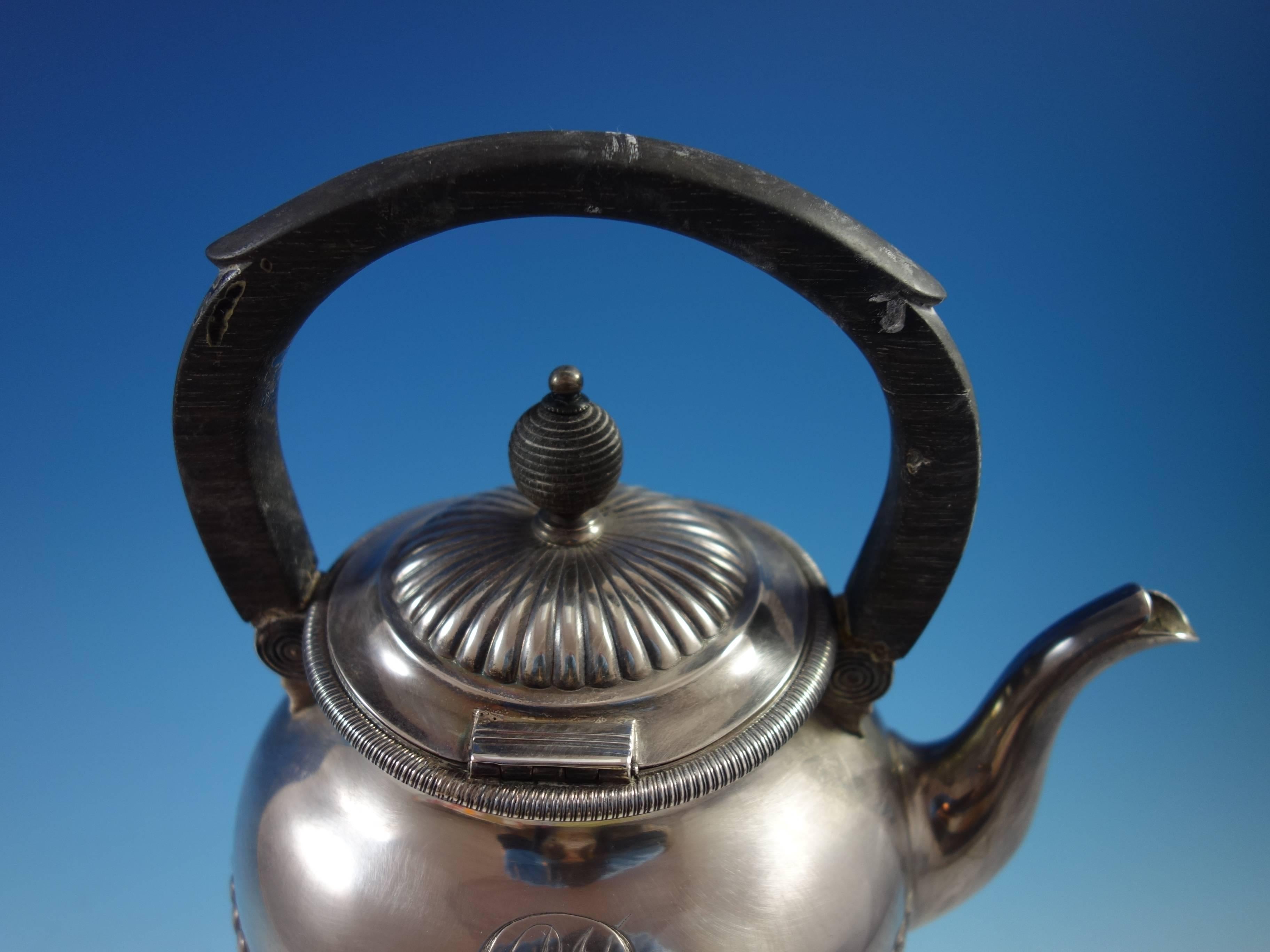 Bigelow, Kennard & Co. sterling silver kettle on stand with a carved ebony handle. The piece is marked #5, it has a scrolly monogram (see photos), measures 9 1/2