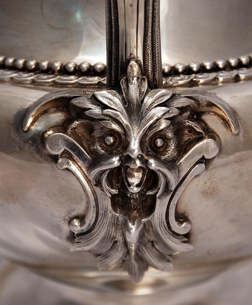 Bigelow Bros. & Kennard coin silver water pitcher depicting a dog with a warrior shield on the handle with two matching dog cartouches on the front end and back end of the water pitcher. Very fine heavy gage silver with fine beading around the belly