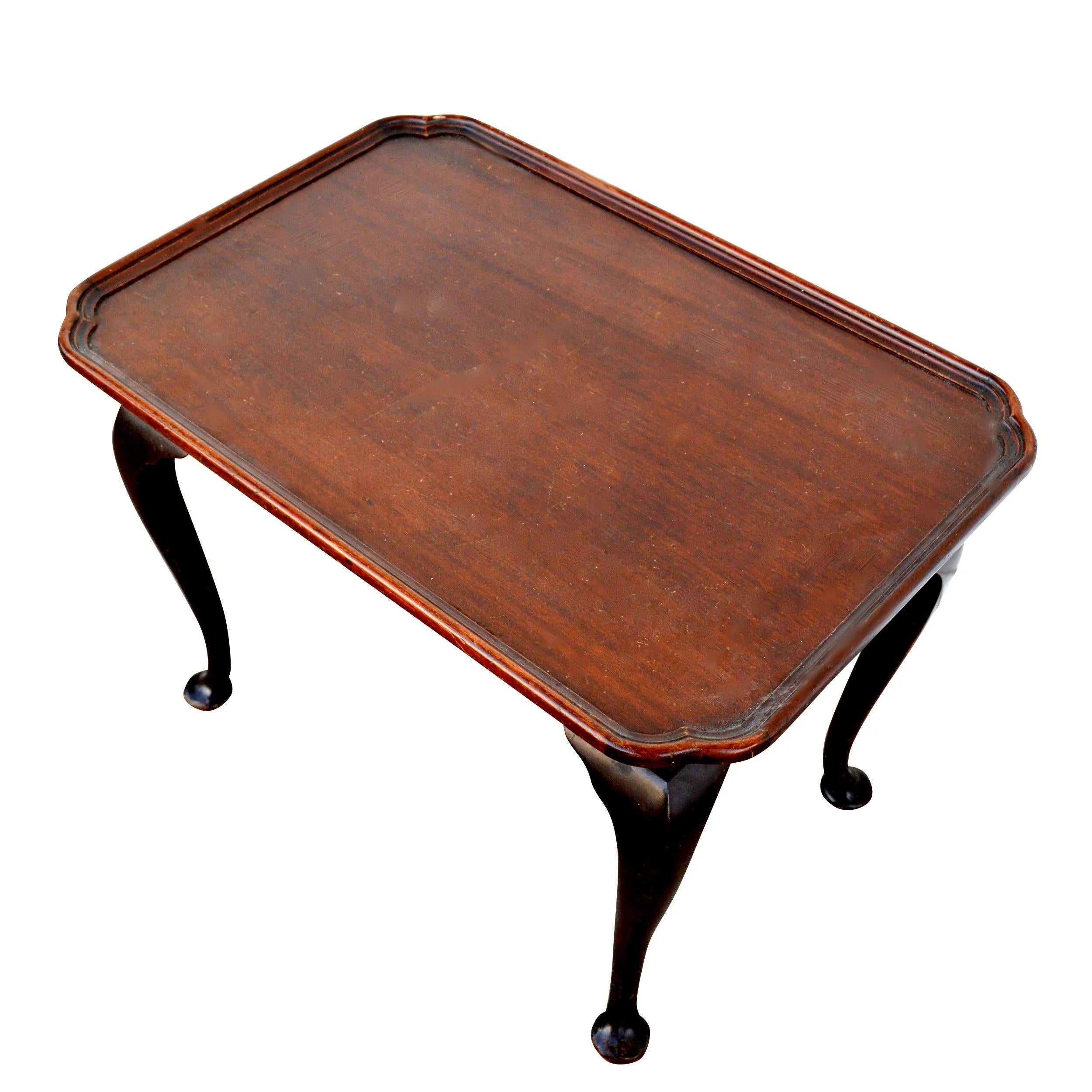 This table is crafted in a beautiful mahogany.  It has a tray shape
top that ends in Queen Anne legs. 

Biggs Furniture is out of Virginia and was known for its reproductions of Colonial furniture. They were purchased by the Kittenger Furniture in