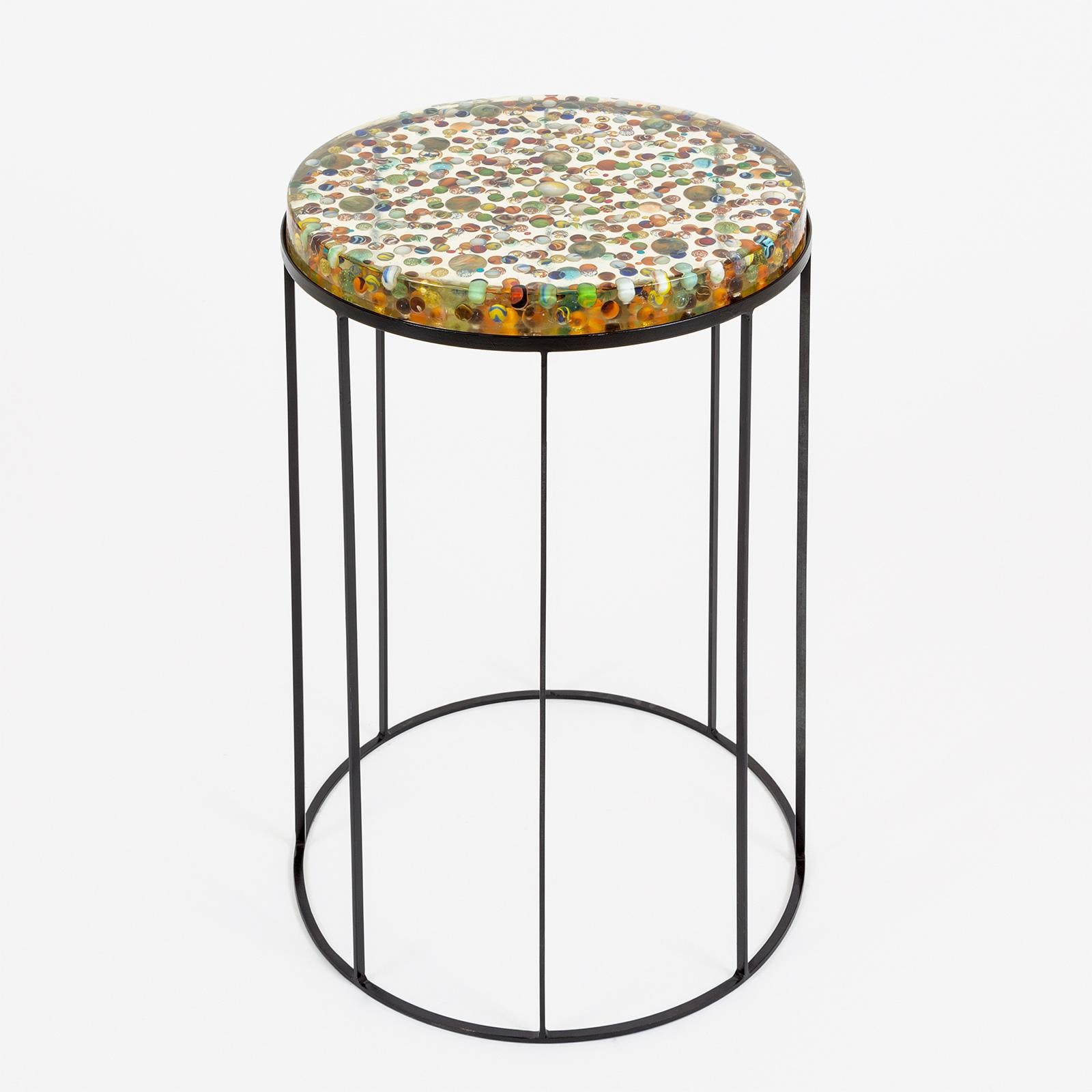 This beautiful side table is linked with memories, represented by little objects, images, memorabilia of Artist’s travel around the world, fragments of her life all combined together to creates stunning tableaux vivants which becomes functional.