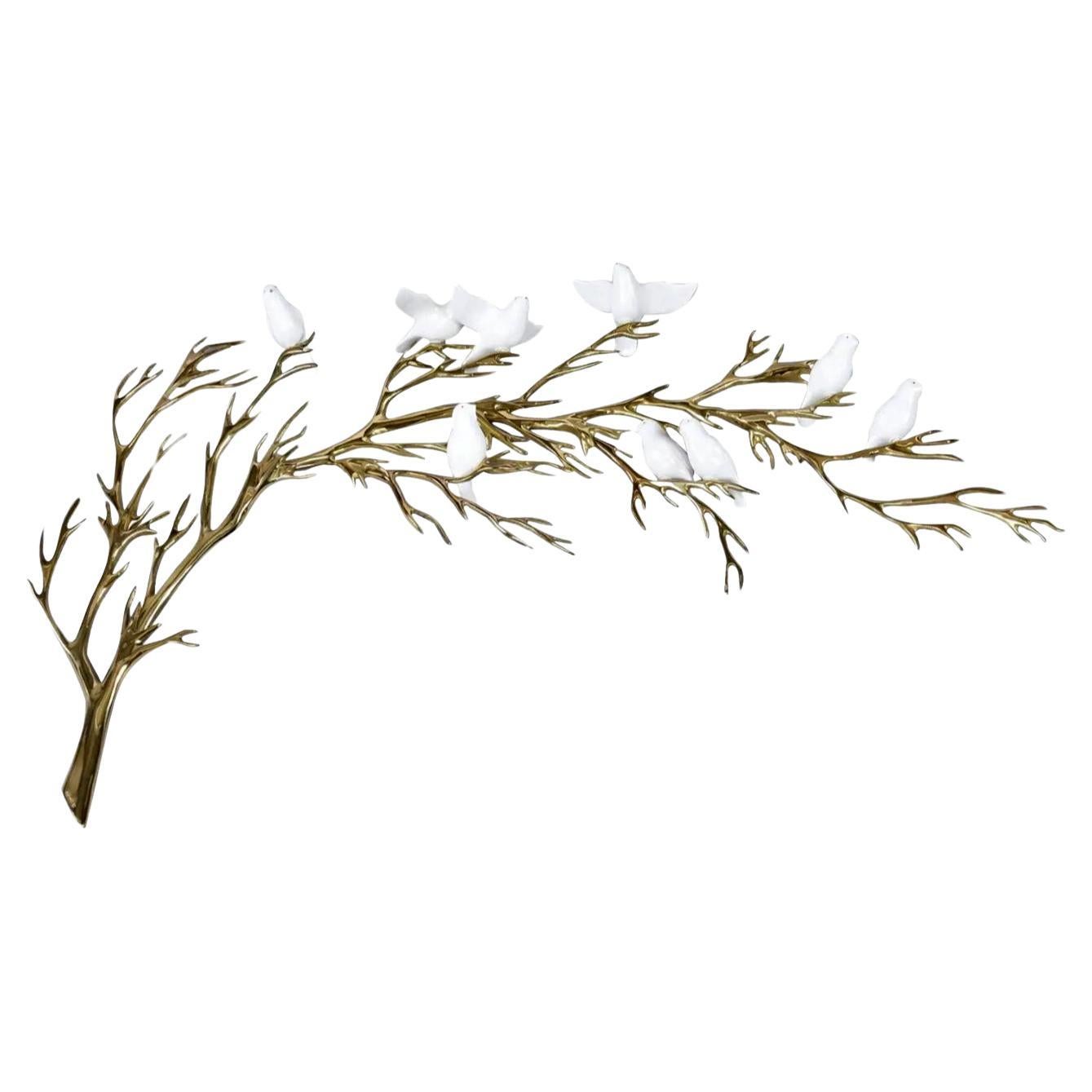 Stunning vintage 1980s Bijan gold colored metal wall sculpture with white porcelain birds. We’ve never seen a vintage wall sculpture like this before. The birds are three dimensional objects affixed to the brass tree branch. The piece exhibits