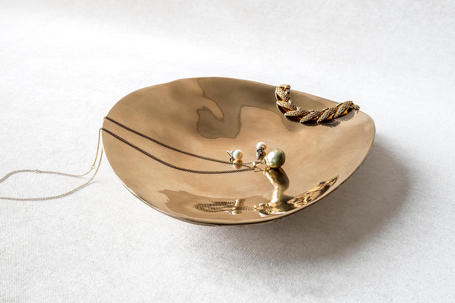 This stunning solid bronze dish is an interior embellishment.
The organic shape is sculpted by hand and polished after casting for a smooth shiny surface.
Inspired by the perfectly imperfect shapes in nature, this home accessory will add a touch