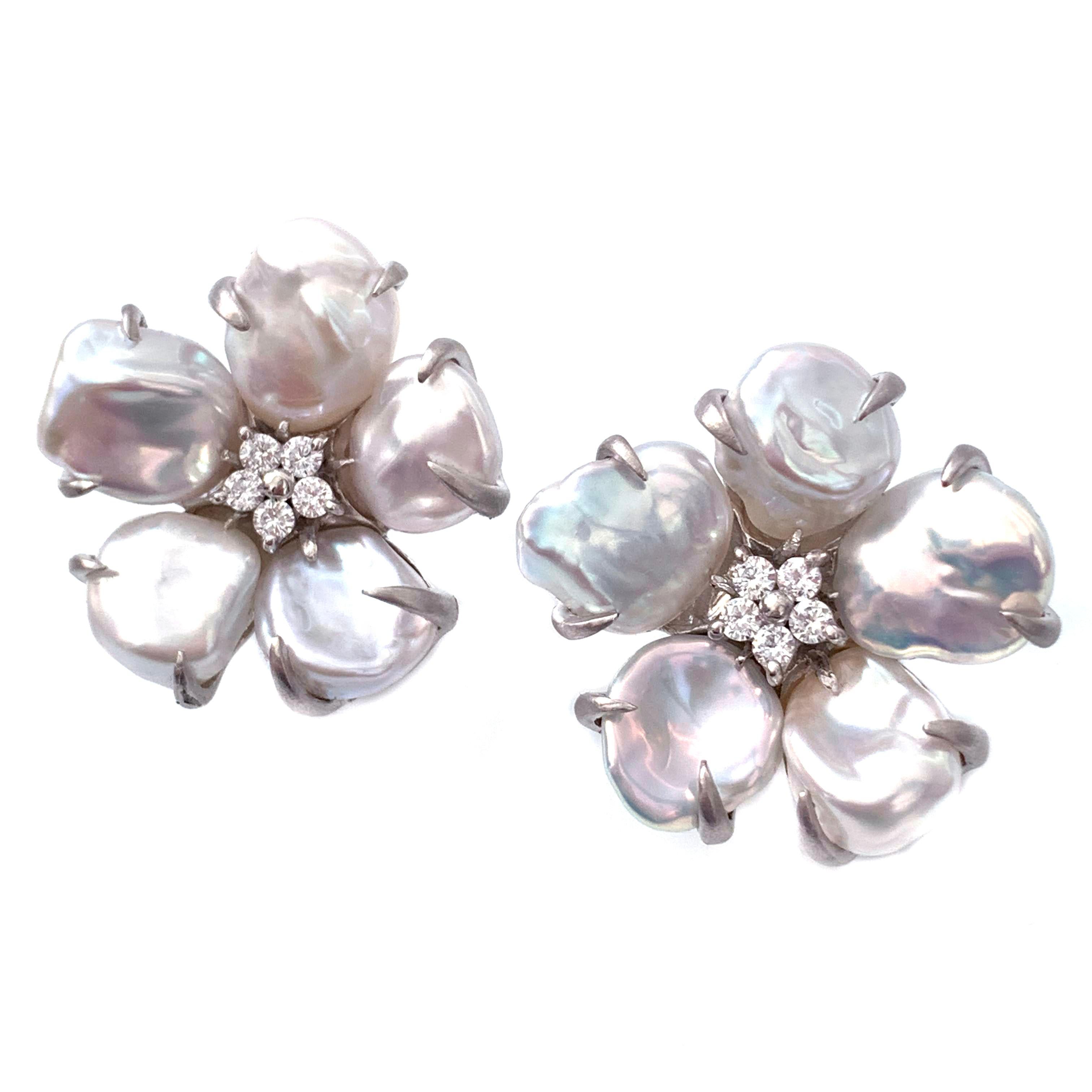 5-petal Baroque Pearl Sterling Silver Flower Earrings

These beautiful flower earrings features lustrous baroque pearls as petal and round faux diamond center, handset in platinum rhodium plated sterling silver, and brush satin finish.  Very