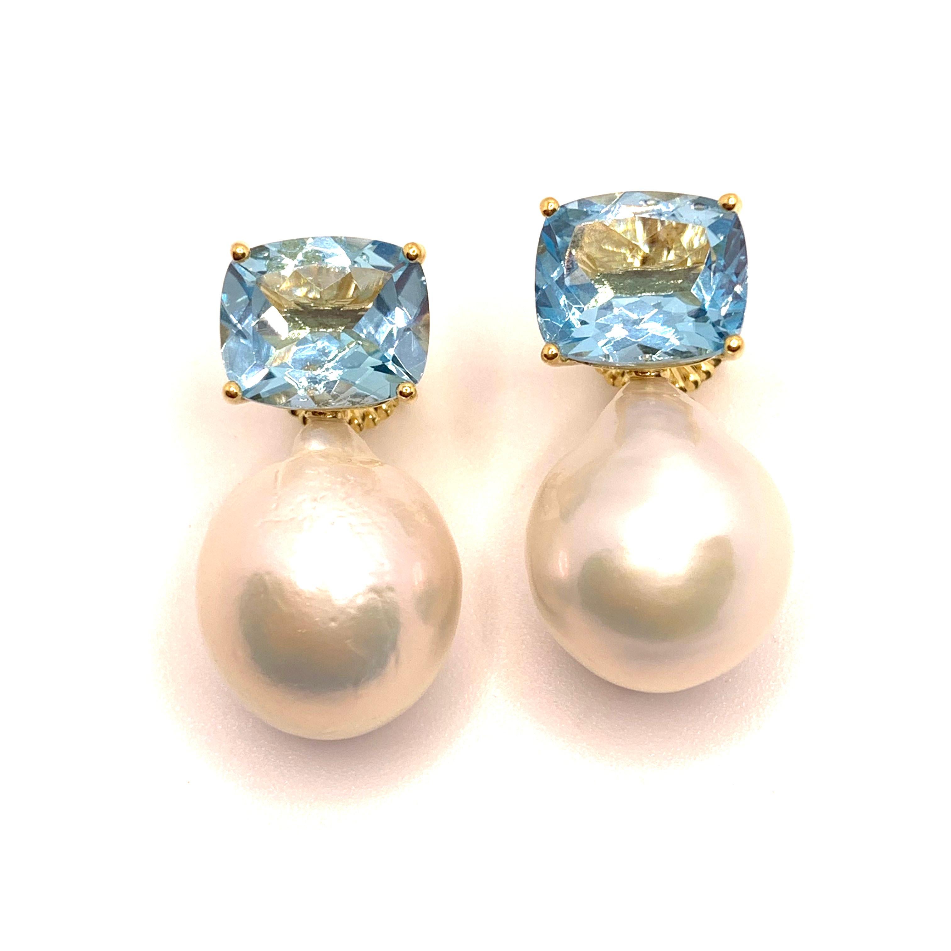 These stunning pair of earrings feature a pair of genuine cushion-cut sky blue topaz and lustrous white cultured baroque pearls, handset in 18K yellow gold vermeil over sterling silver. The pearls measure 16mm width and 20mm height offering