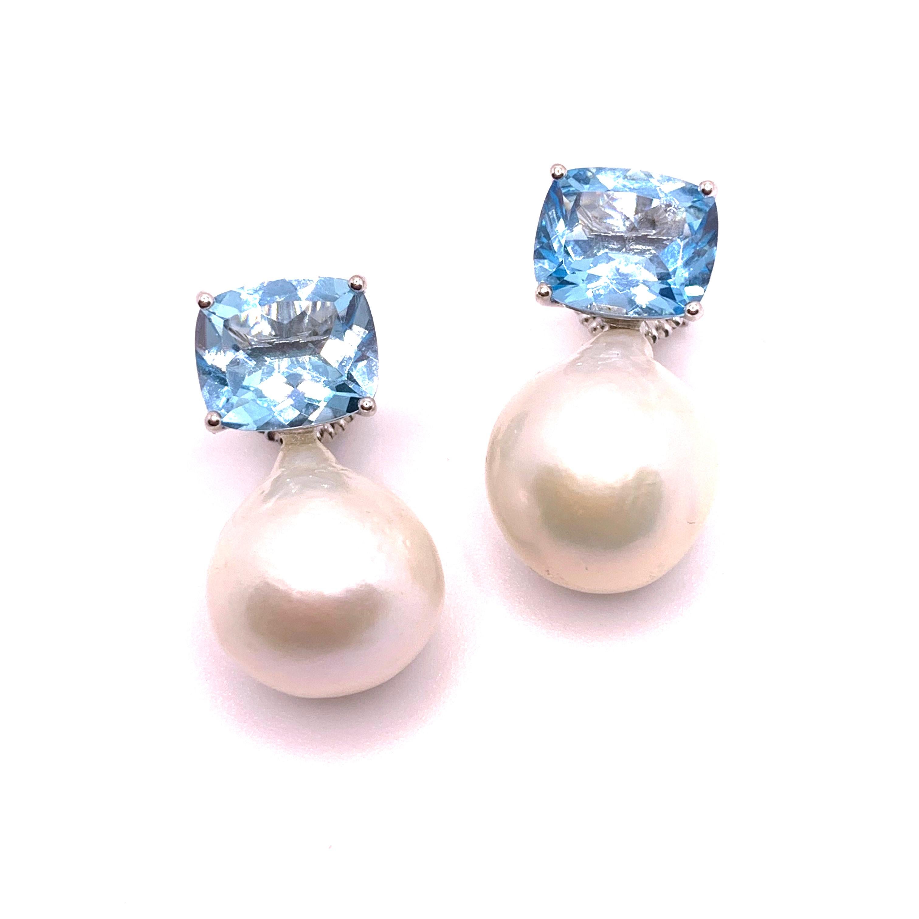 These stunning pair of earrings feature a pair of genuine cushion-cut sky blue topaz and lustrous white cultured baroque pearls, handset in platinum rhodium plated over sterling silver. The pearls measure 16mm width and 19mm height offering