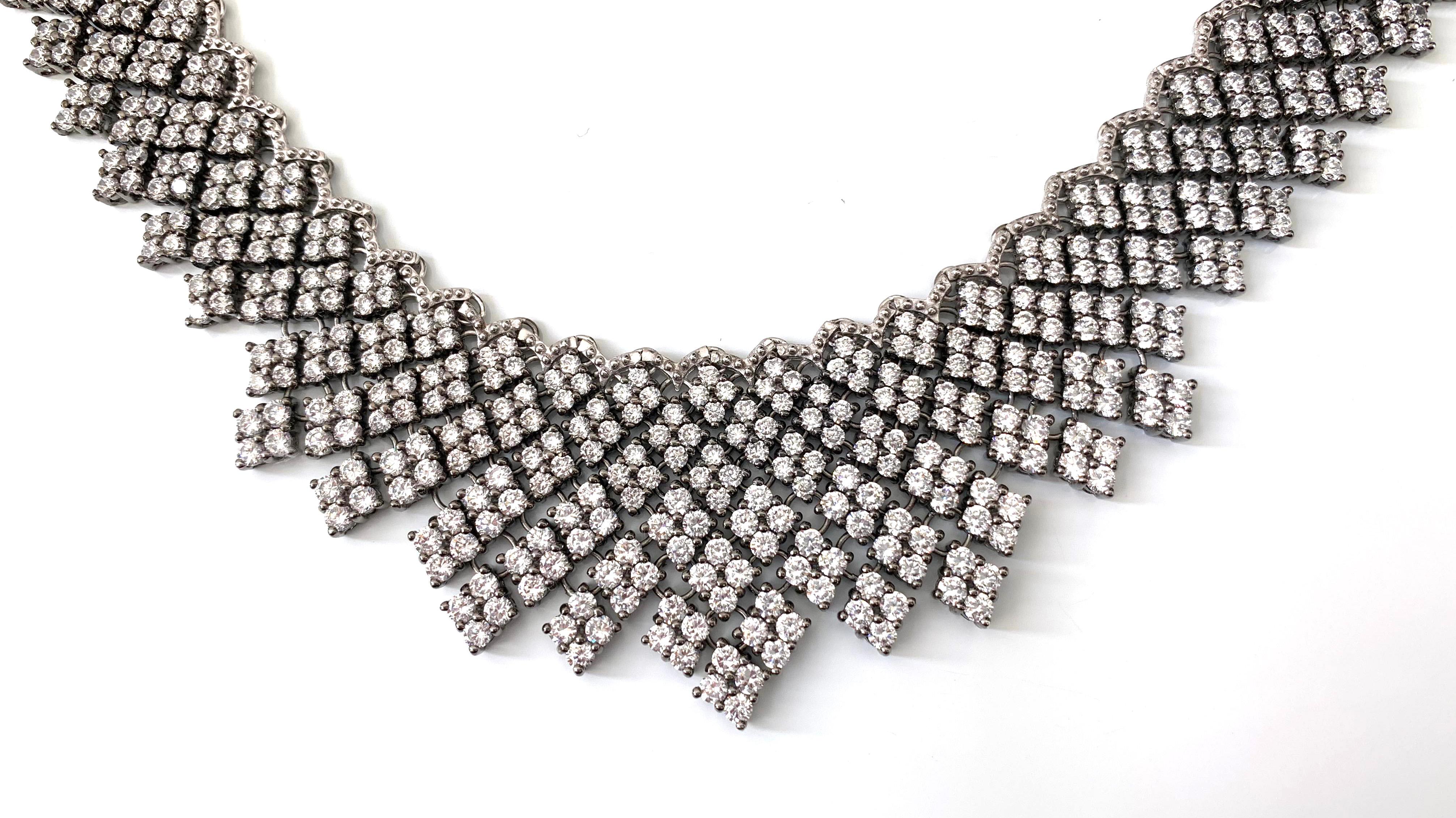 Elegant multi-link diamond shape cubic zirconia bib necklace. Over 800 pieces of round Cubic Zirconia individually handset in platinum black rhodium plated sterling silver. Push clasp closure with '8' safety lock. Each part is interconnected making