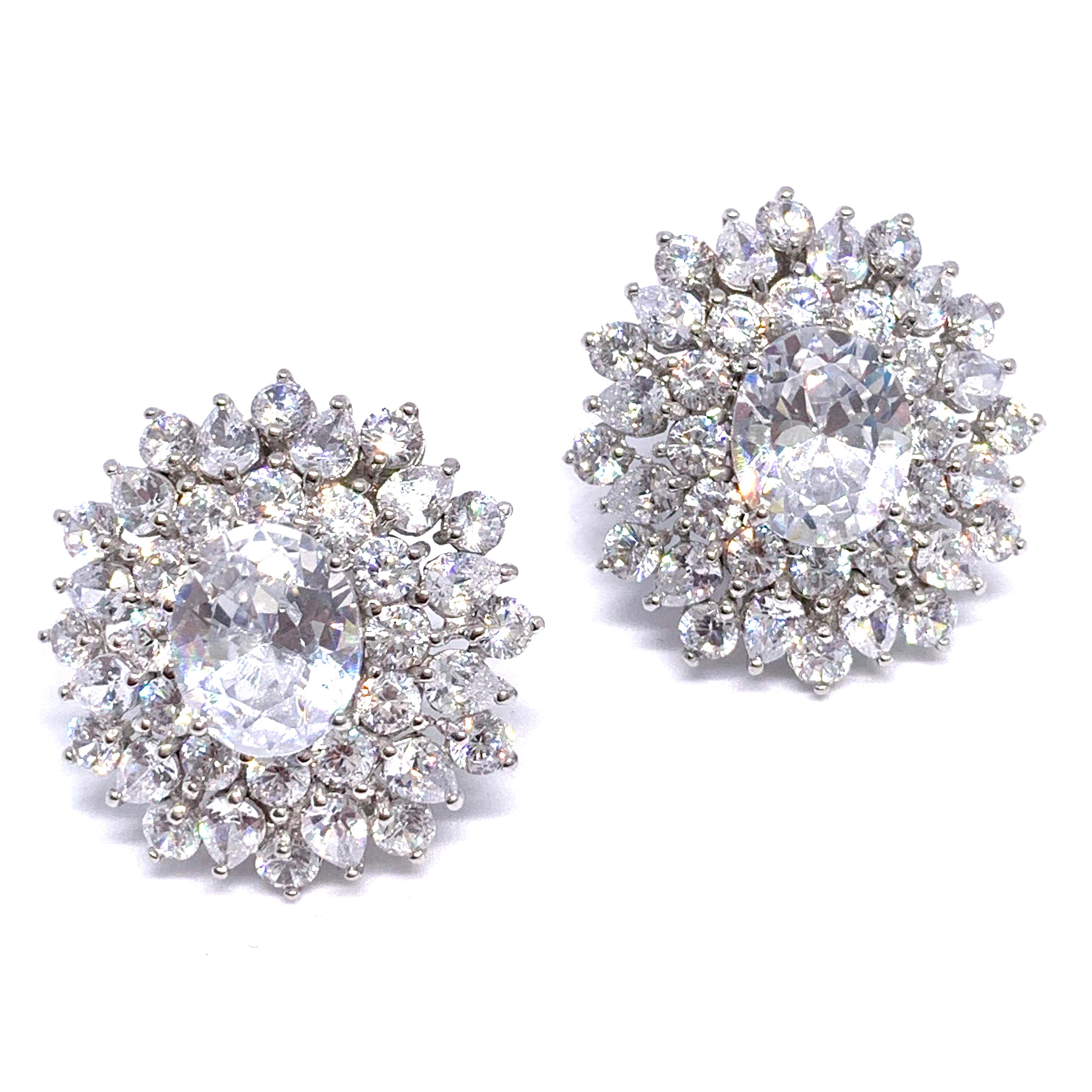 Stunning Bijoux Num elegant faux diamond cluster earrings. 

These earrings feature top quality oval-shape faux diamonds, adorned with 72 pcs of pear shape and round cubic zirconia, handset in platinum rhodium plated sterling silver. The earrings