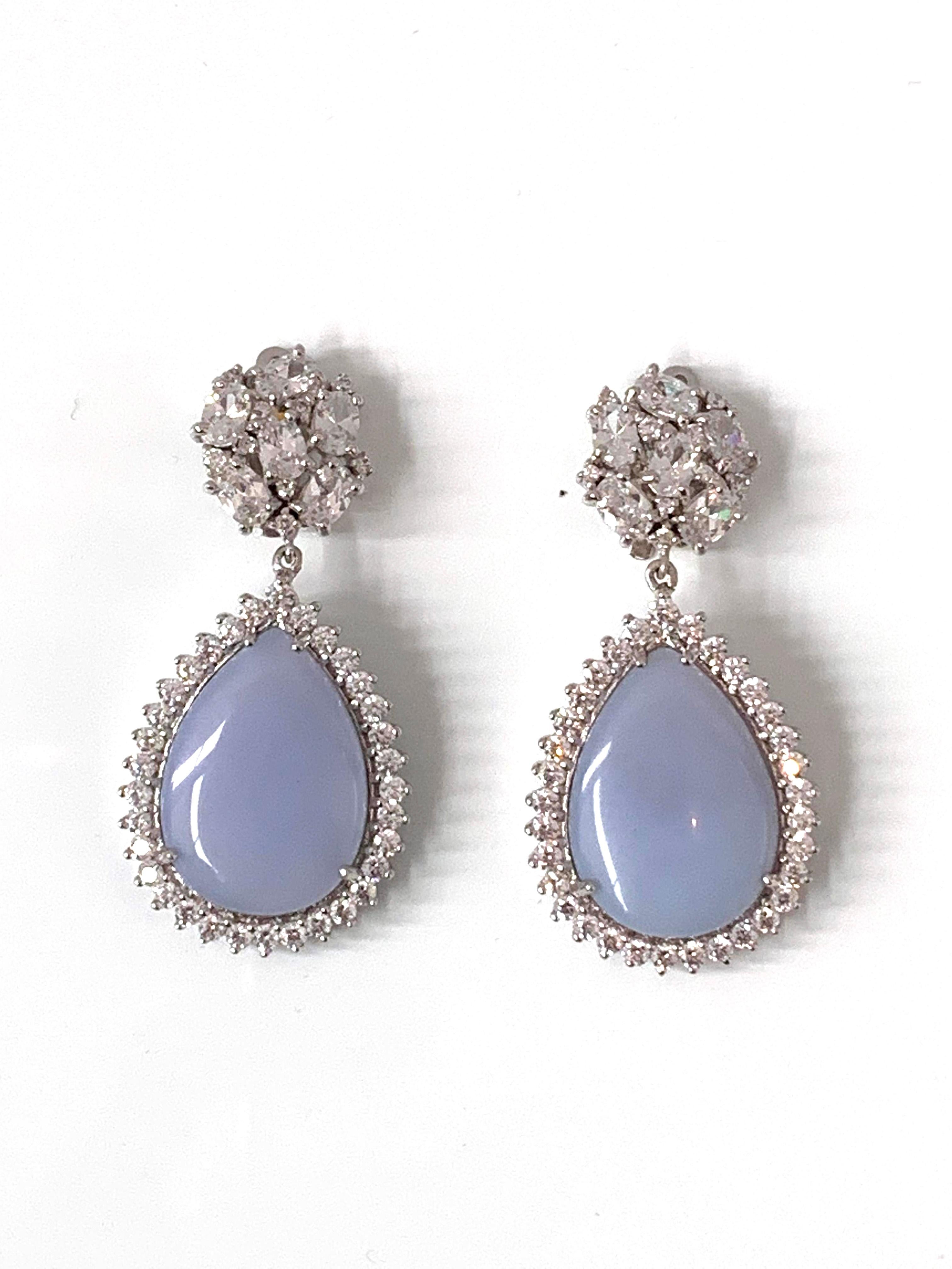 Encrusted faux diamond top and pear shape chalcedony drop earrings surrounded with faux diamond CZ. These earrings feature 2 beautiful iridescent cabochon-cut pear shape chalcedony and over 100pc of round and oval cubic zirconia, handset in platinum