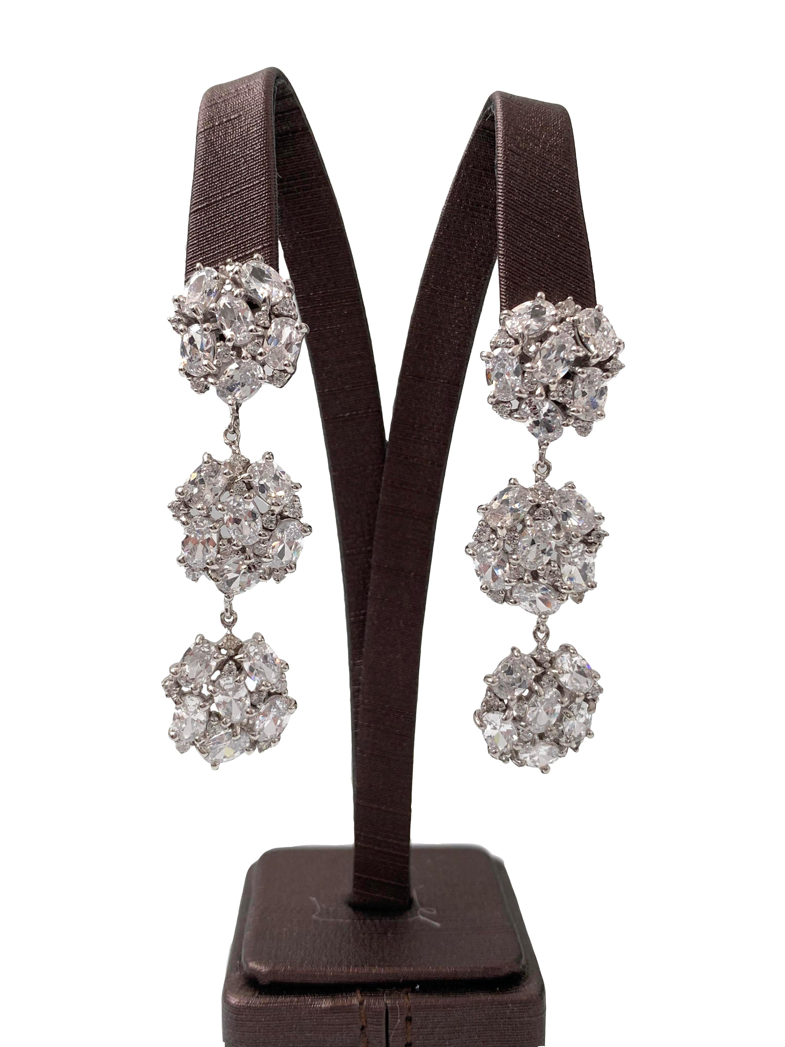 Stunning 3-tier encrusted faux diamond dangle earrings. These earrings feature 90pcs of round and oval cubic zirconia (AAA quality), handset in platinum rhodium plated sterling silver. The earrings measure approximately 2.5