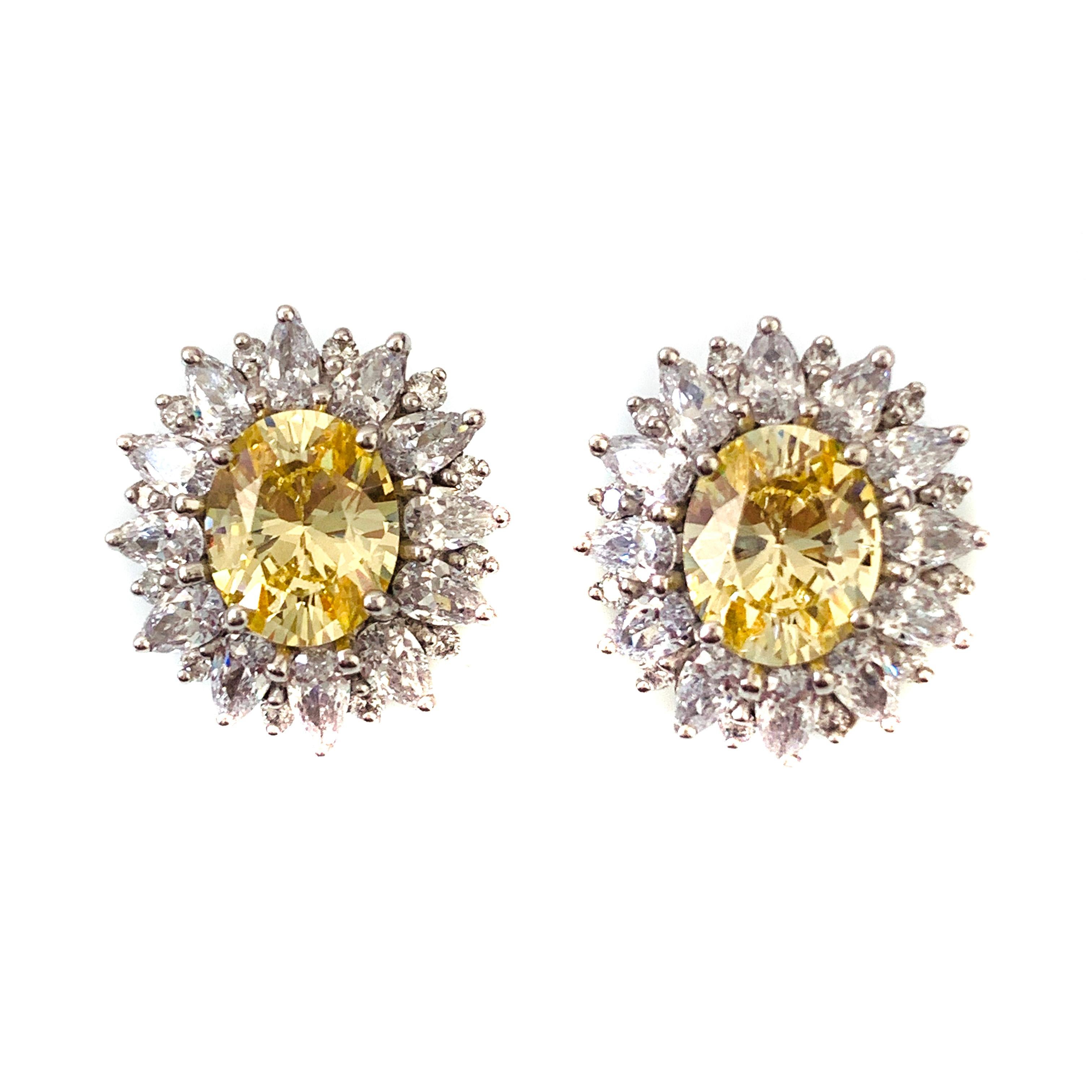 Bijoux Num fabulous faux canary diamond earrings. These earrings feature top quality oval-shape faux canary diamond, adorned with 48 pcs of pear shape and round cubic zirconia, handset in platinum rhodium plated sterling silver. The earrings measure