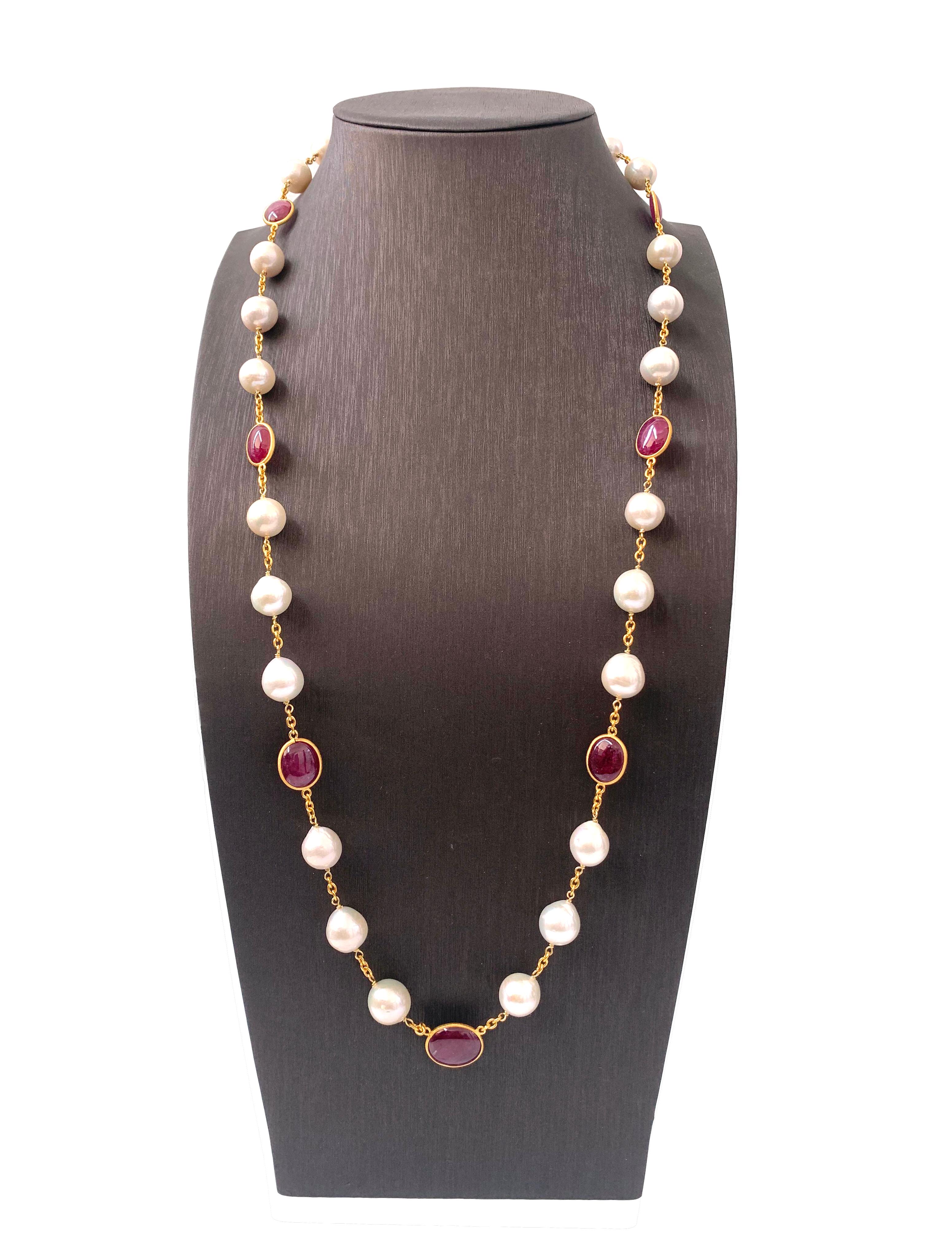 Contemporary Genuine Ruby and Cultured Baroque Pearl Long Station Necklace.

The necklace features 7 beautiful pink-ish oval cabochon-cut genuine rubies (86 carats total weight) and 24 high-luster genuine cultured baroque pearls. The pearls measure