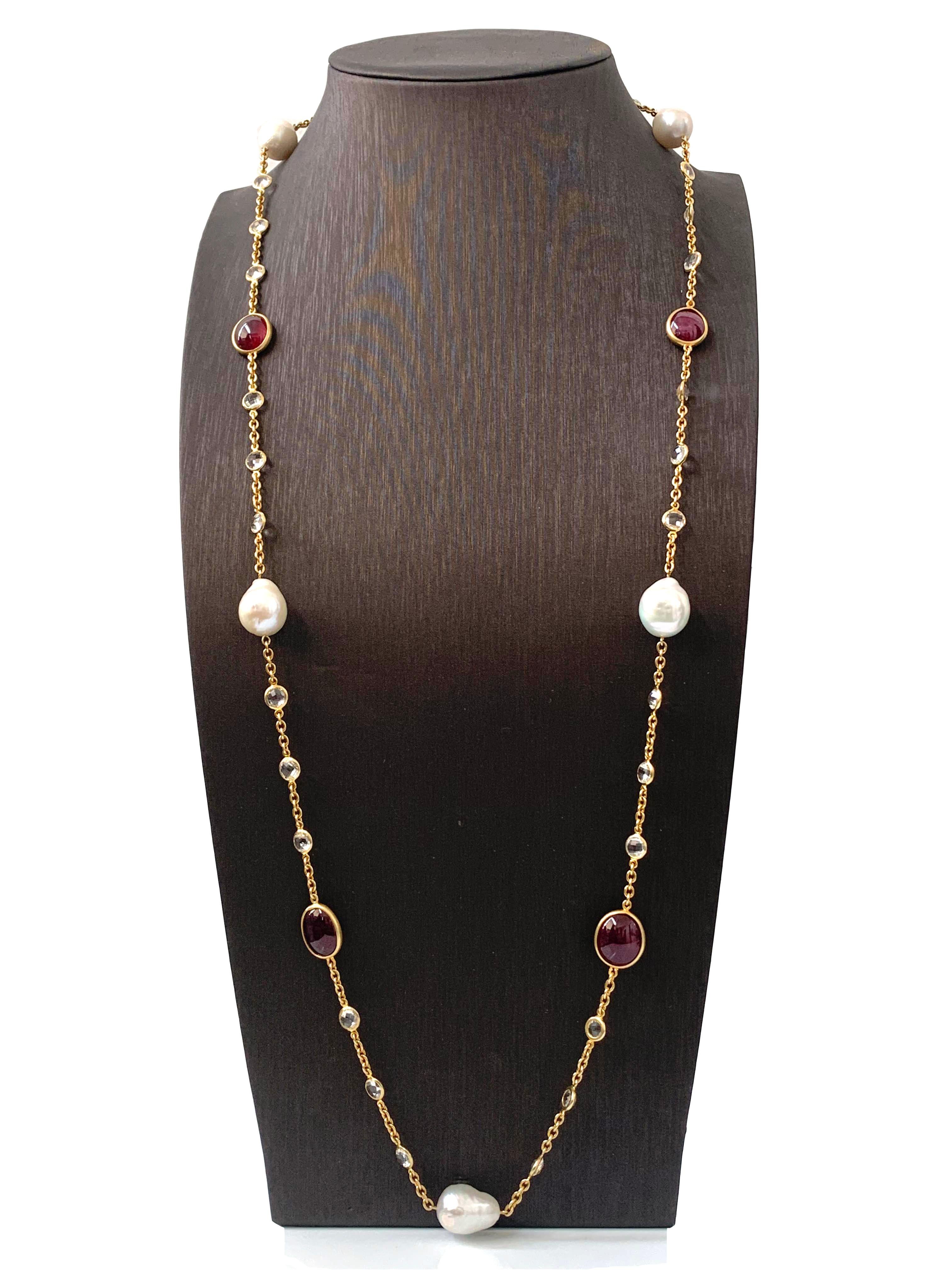 Contemporary Genuine Ruby, Cultured Baroque Pearl, and White Topaz Long Station Necklace.

The necklace features 4 beautiful pink-ish oval cabochon-cut genuine rubies (58 carats total weight), 5 high-luster genuine cultured baroque pearls, and 30