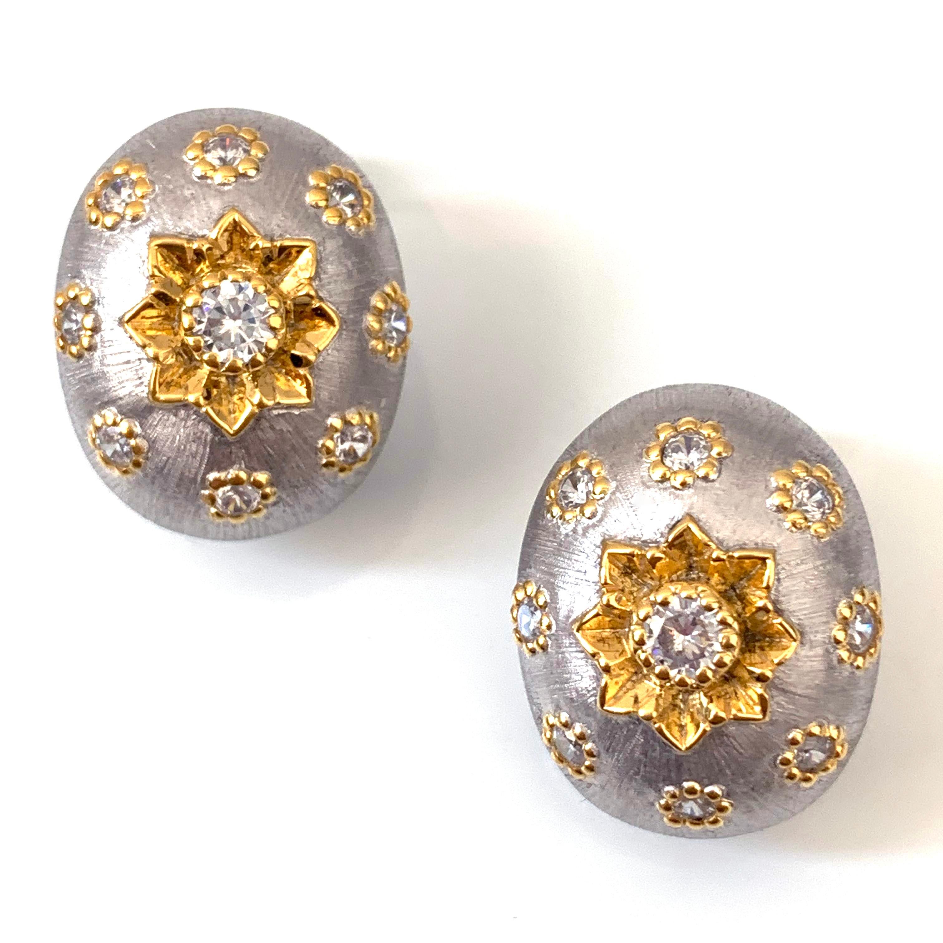 This pair of stunning hand-engraved oval bombe shape clip-on earrings feature hand-engraved flower, handcrafted Italian Rigato etching technique, and are handset with simulated diamond cz. Platinum rhodium and 18k Gold two tone plated sterling