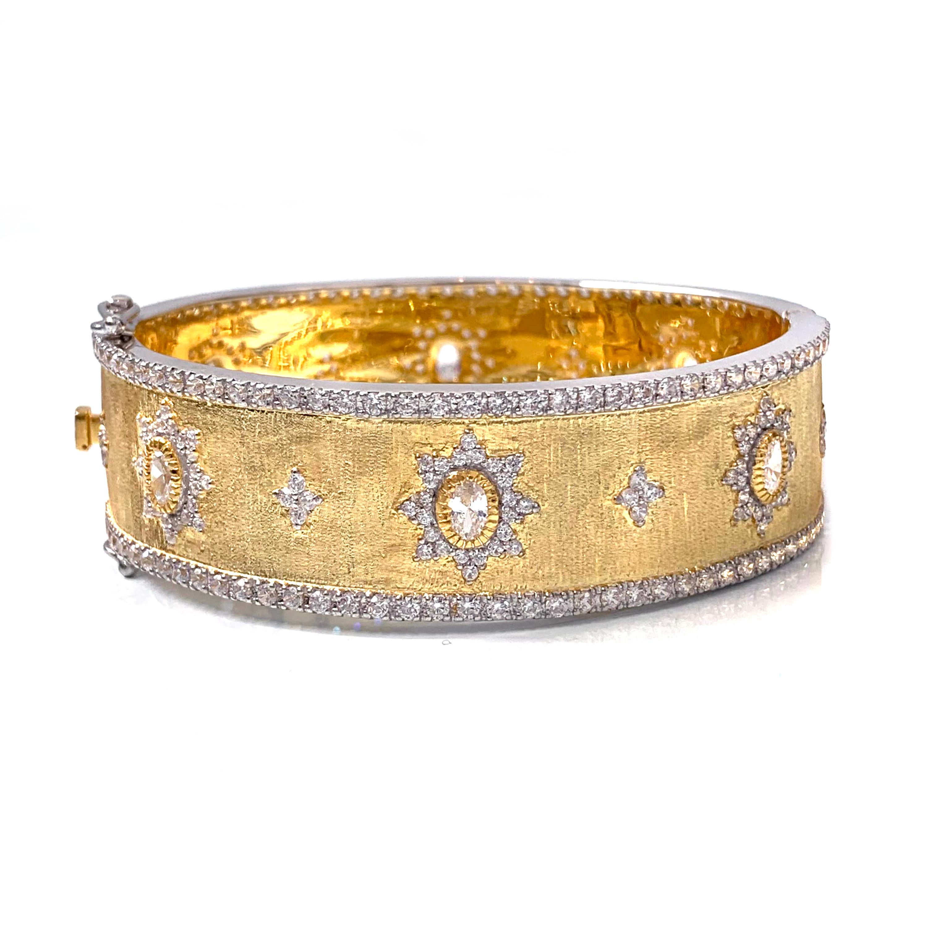 Bijoux Num hand-engraved star pattern vermeil bangle bracelet. 

This beautiful bracelet features over 340 pcs of oval and round faux diamond cubic zirconia (CZ), handcrafted Italian 