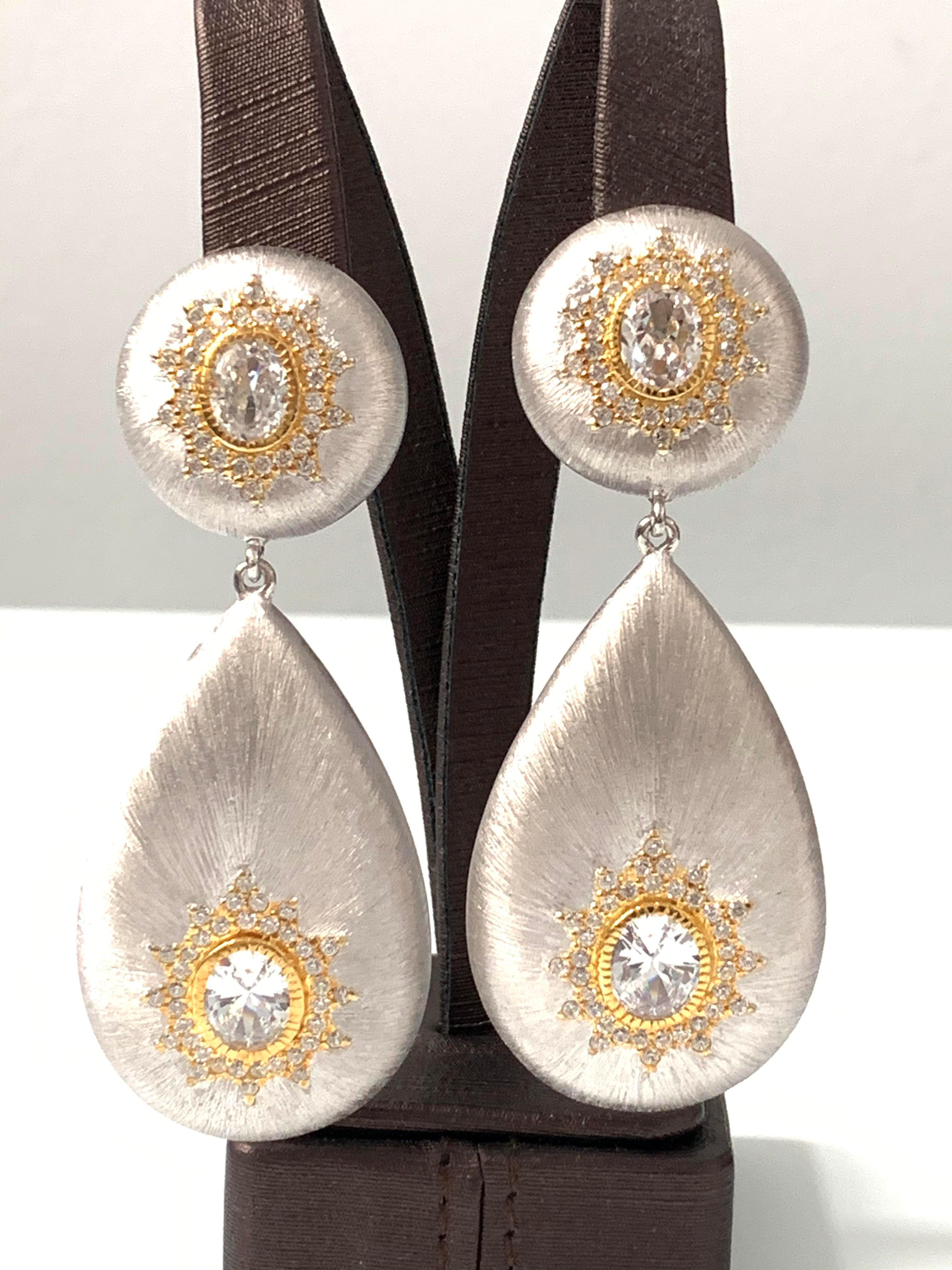 Stunning hand-engraved large teardrop clip-on earrings handset with Cubic Zirconia. The rigato engraving texture are all done by hand creating a beautiful unique look. Top part has diameter of 0.88