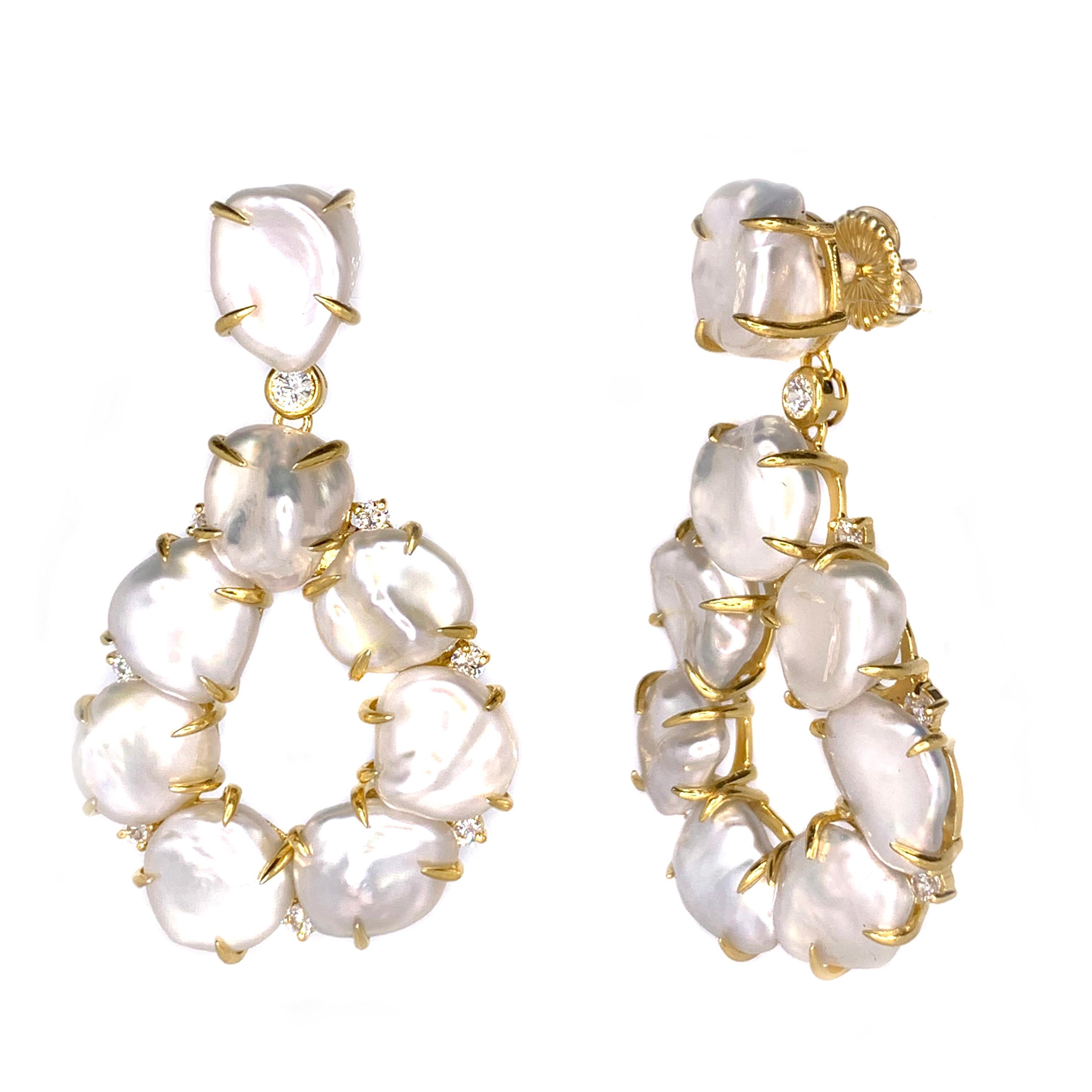 Bijoux Num Keishi Pearl Open Pear Drop Earrings

These stunning pair of earrings features 16 pieces of lustrous cultured Japanese Keishi pearls adorned with round simulated diamonds, handset in 18k yellow gold vermeil over sterling silver.  Straight