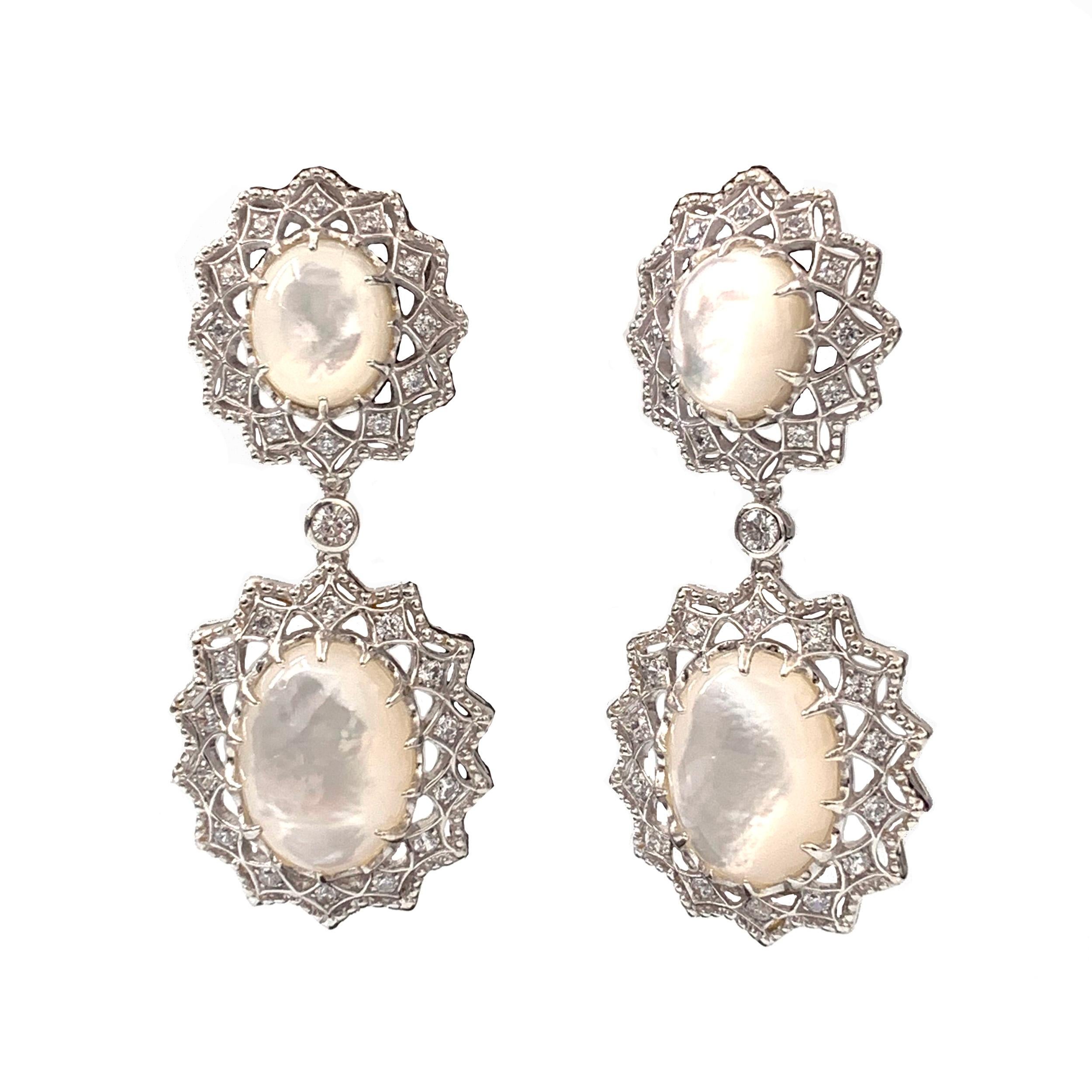 Beautiful laced drop earrings featuring oval mother of pearls, round cubic zirconias, and silver bead edging handset in platinum rhodium plated sterling silver. Top part has diameter of 0.75