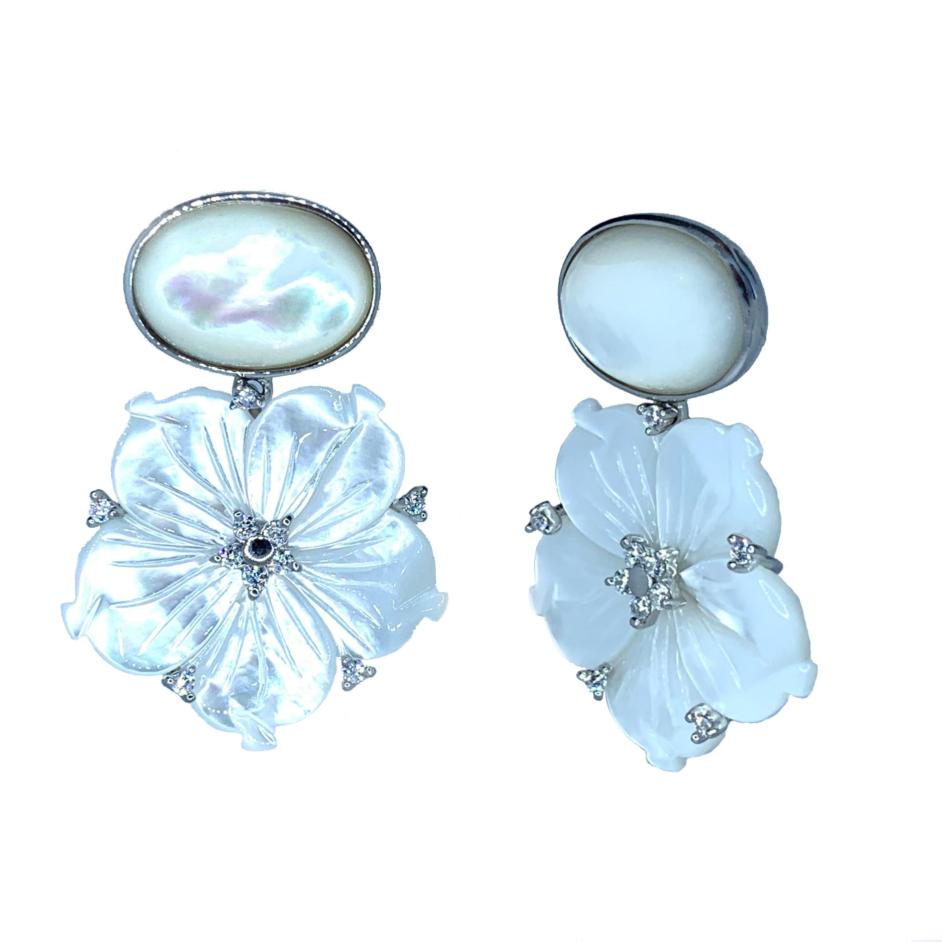 Stunning Oval Cabochon and Carved Flower Mother of Pearl Drop Earrings

This gorgeous pair of earrings features oval cabochon-cut mother of pearl and beautifully carved white mother of pearl flower, adorned with round simulated diamond, handset in
