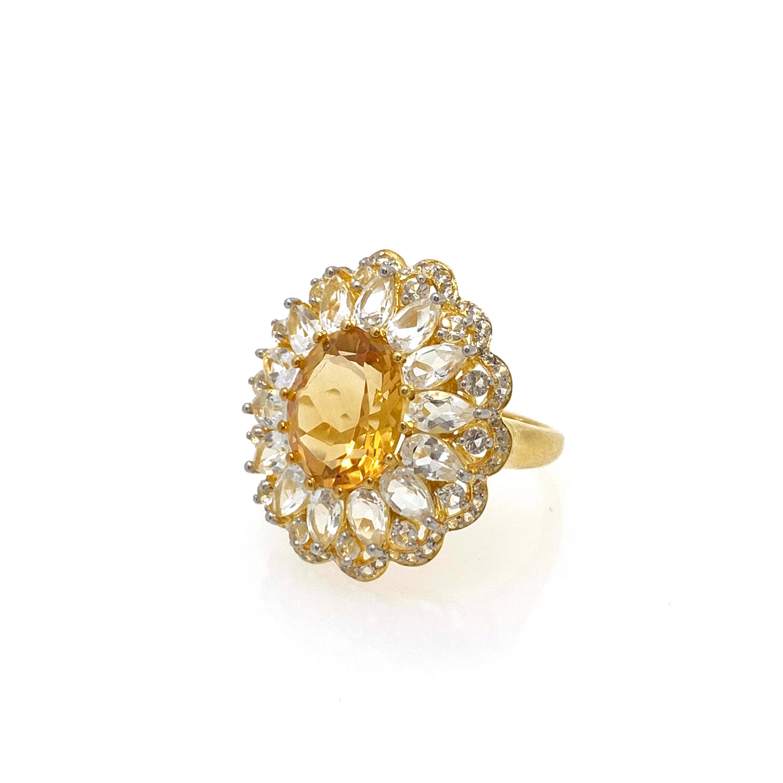 Bijoux Num Oval Citrine and White Topaz Cocktail Ring

This bold cocktail ring features beautiful round Brazilian citrine, surrounded with  pear shape and round white topaz, handset in 18k yellow gold vermeil over sterling silver. The sparkles from