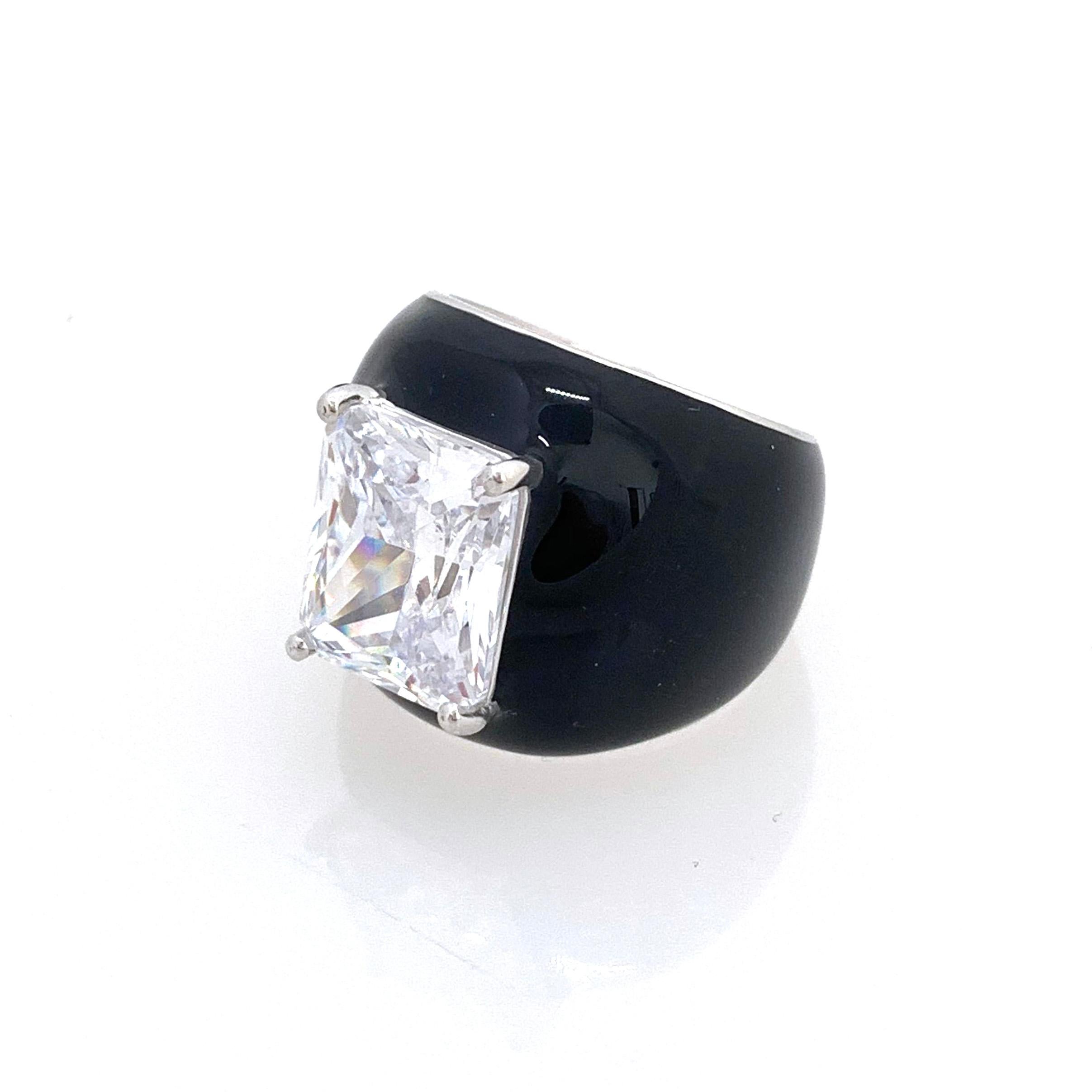 Bijoux Num Faux Diamond Black Enamel Bombe Dome Ring

This bold cocktail ring features beautiful top quality 6ct radiant-cut faux diamond cubic zirconia, handset in platinum rhodium plated sterling silver. The entire ring is sheathed in shiny black