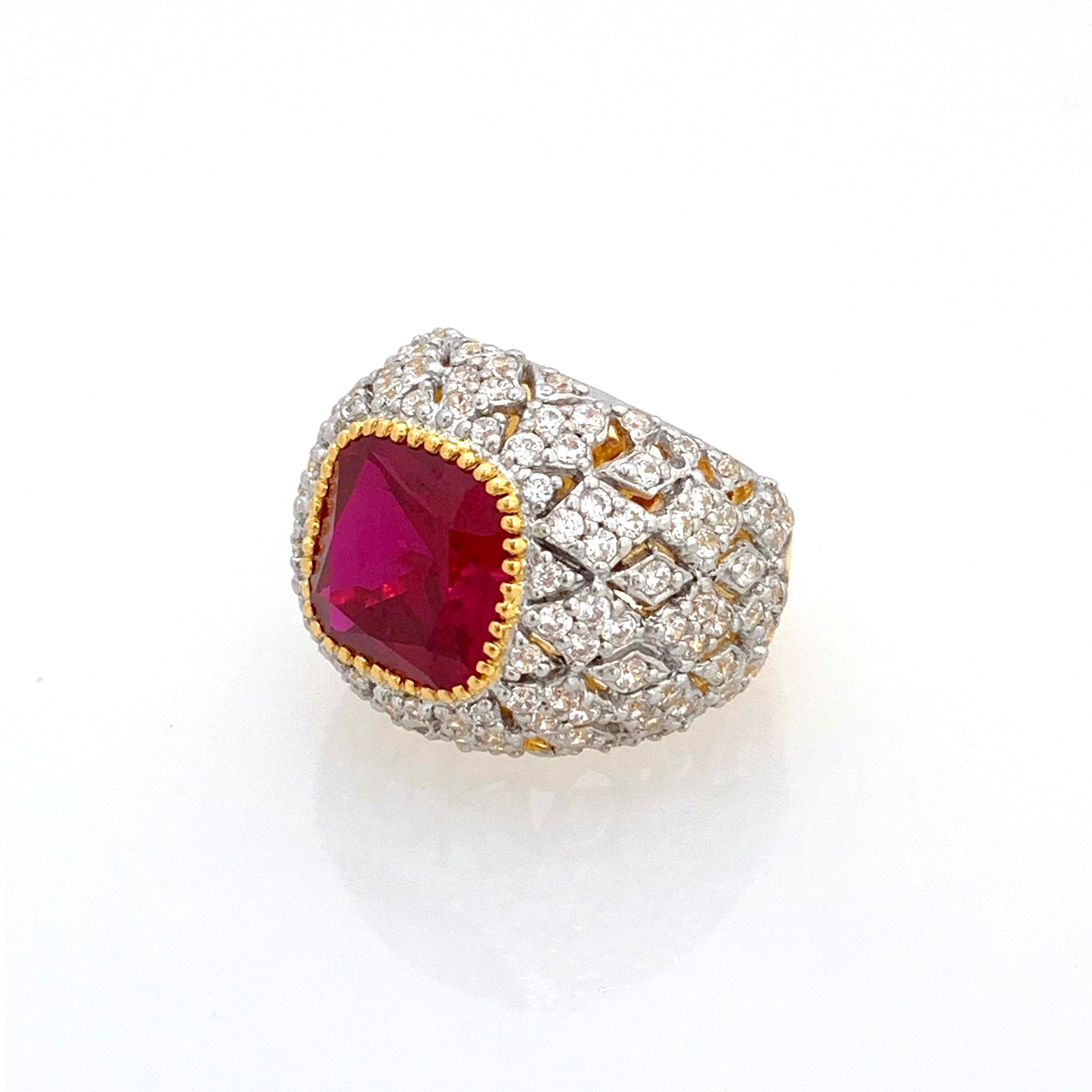 Bijoux Num Sterling Silver Lab Ruby Bombe Dome Ring

This bold cocktail ring features beautiful top quality 5ct cushion-cut lab created ruby, surrounded with 136 round faux diamonds, handset in 18k gold vermeil with platinum rhodium over sterling