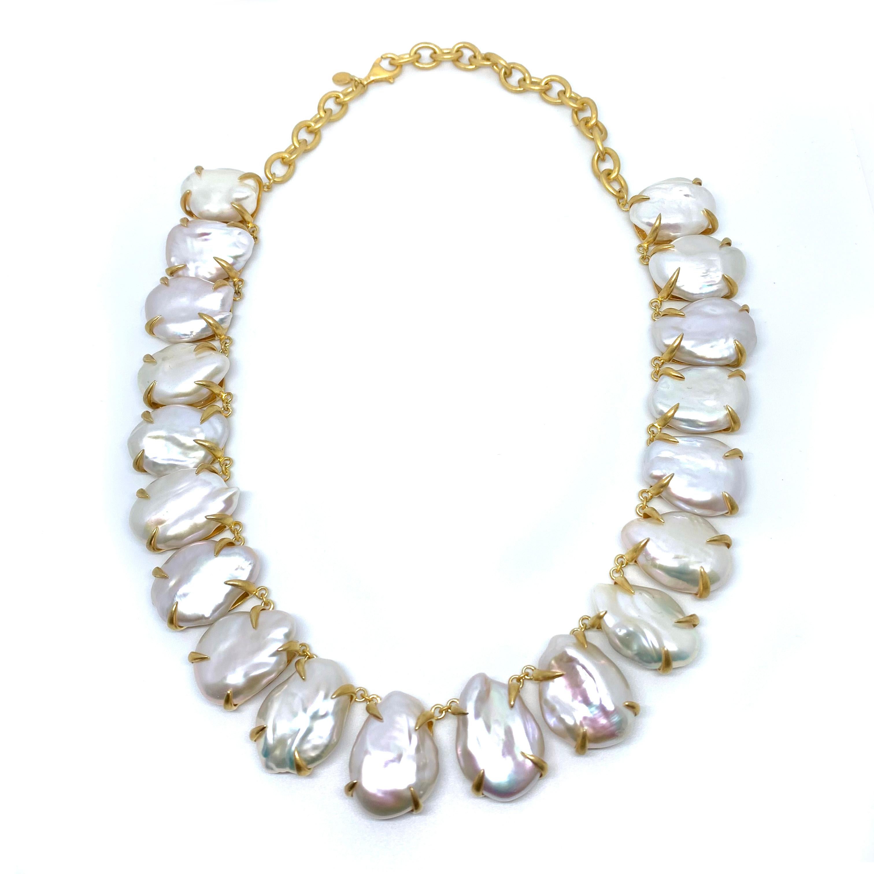 Stunning large lustrous white baroque pearl necklace. The necklace features 19 pieces of beautiful high-luster cultured white flat baroque pearls, handset in 18k yellow gold vermeil over sterling silver with brush satin matte finish. Each pearl