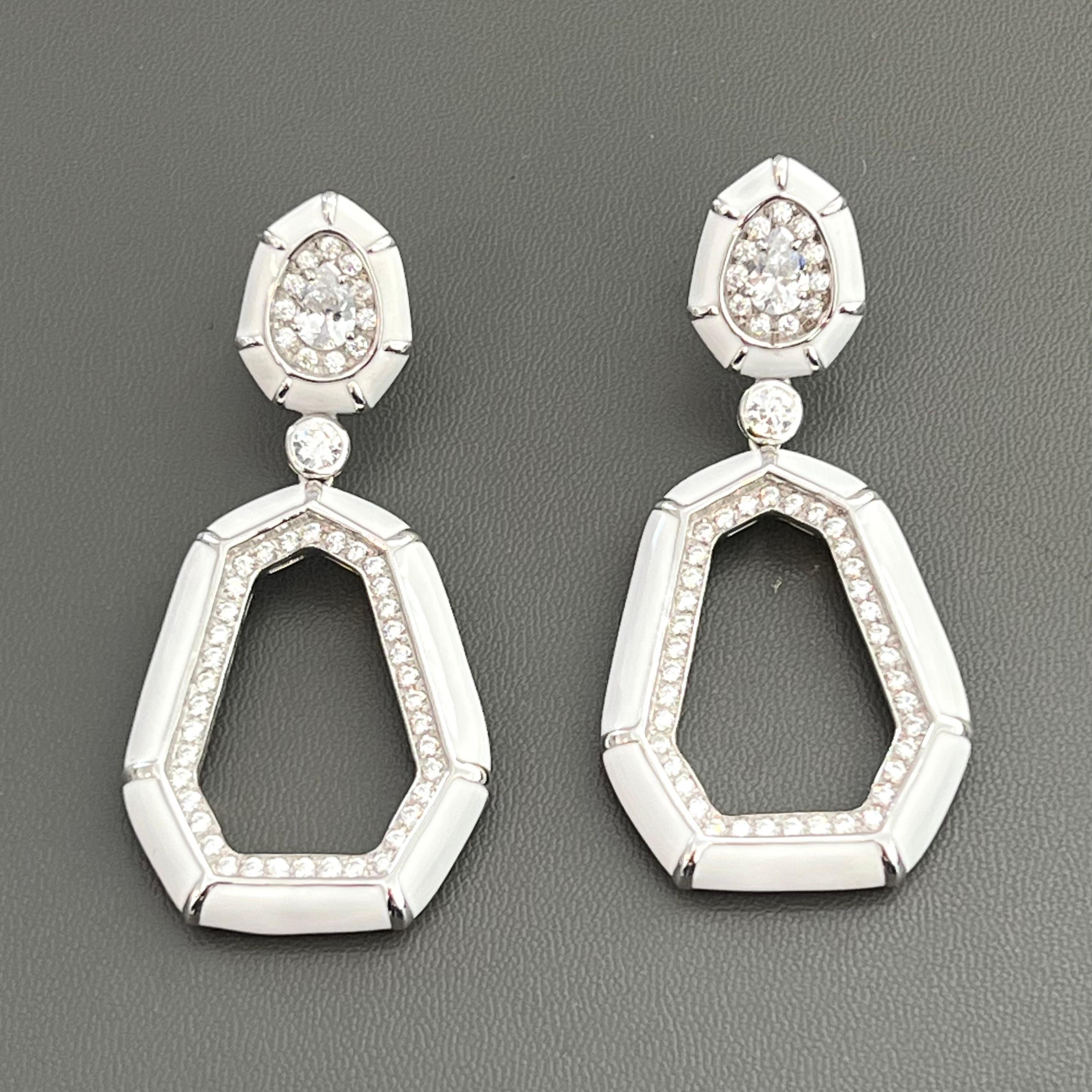Stunning White Enamel Septagon Door Knocker earrings. Handset with round and pear shape simulated diamonds on platinum rhodium plated over sterling silver and finished with shiny white enamel. The earrings are 2-1/2
