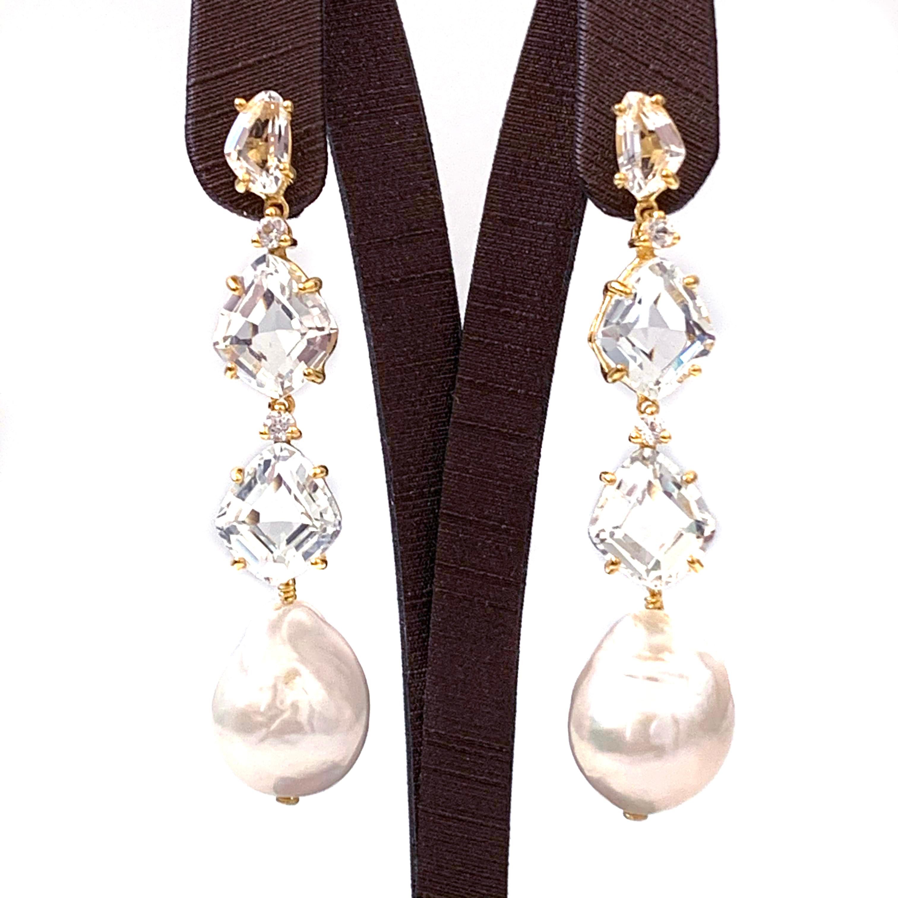 Bijoux Num White Topaz and Baroque Pearl Elongate Dangle Earrings

These earrings feature genuine fancy-cut white topaz, round white sapphire, and white baroque pearl drop. The baroque pearls measured 14x17mm. Handset and wire wrapped in 18k gold