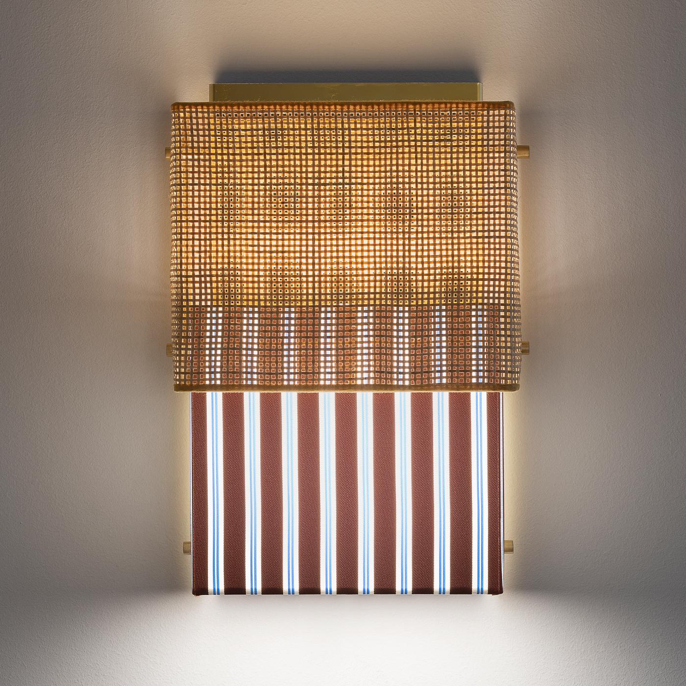 One of the most iconic designs of the 20th century is the bikini; this famous style inspired this mounted wall lamp made from two pieces of fabric. An upper part in rattan sits above rust-colored, striped Trevira fabric from the Milan-based textiles