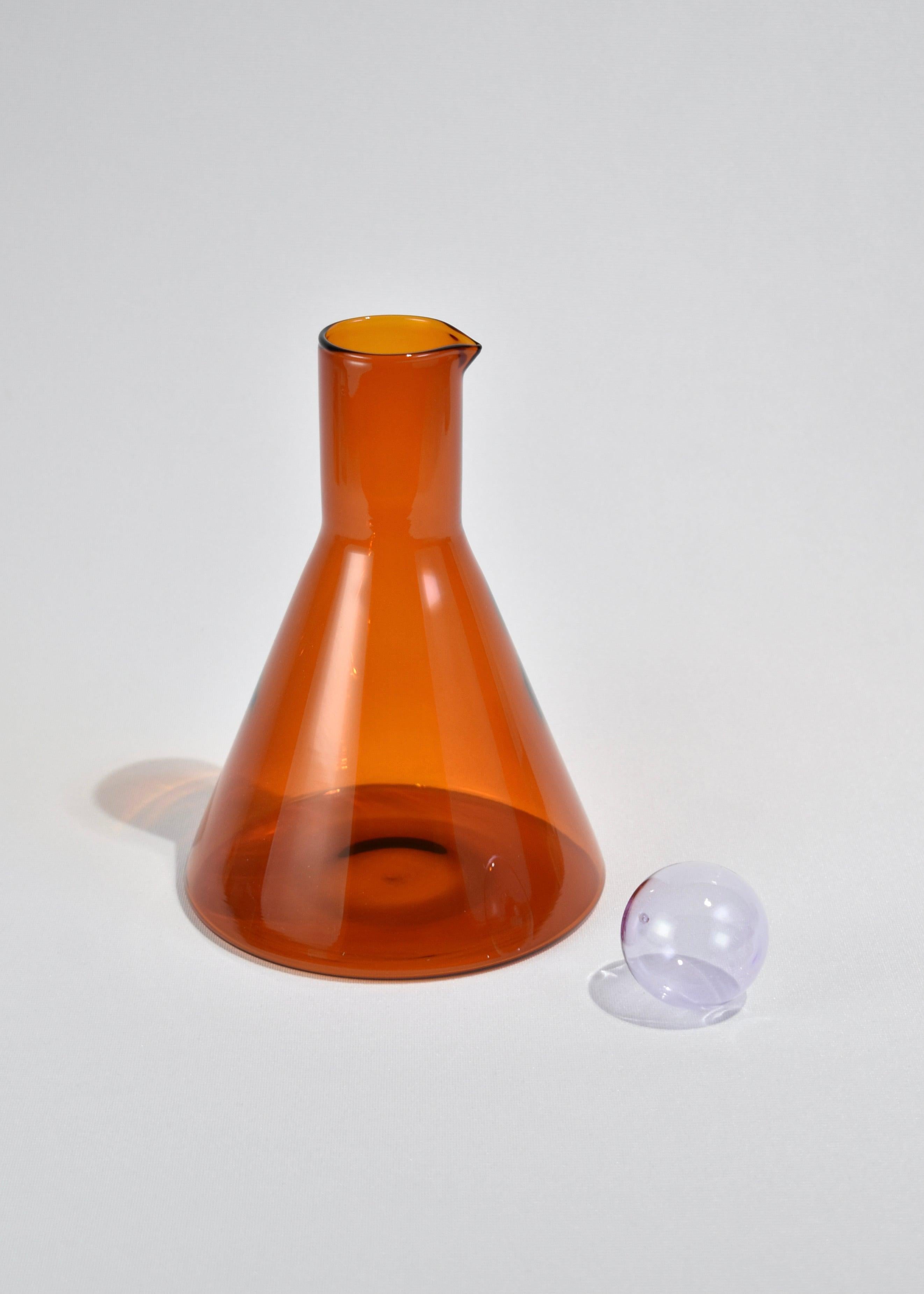 Glass carafe in amber with lilac sphere stopper. Designed by Sophie Lou Jacobsen in New York.

Made of lightweight and durable borosilicate glass. Each holds 32 oz. of liquid.