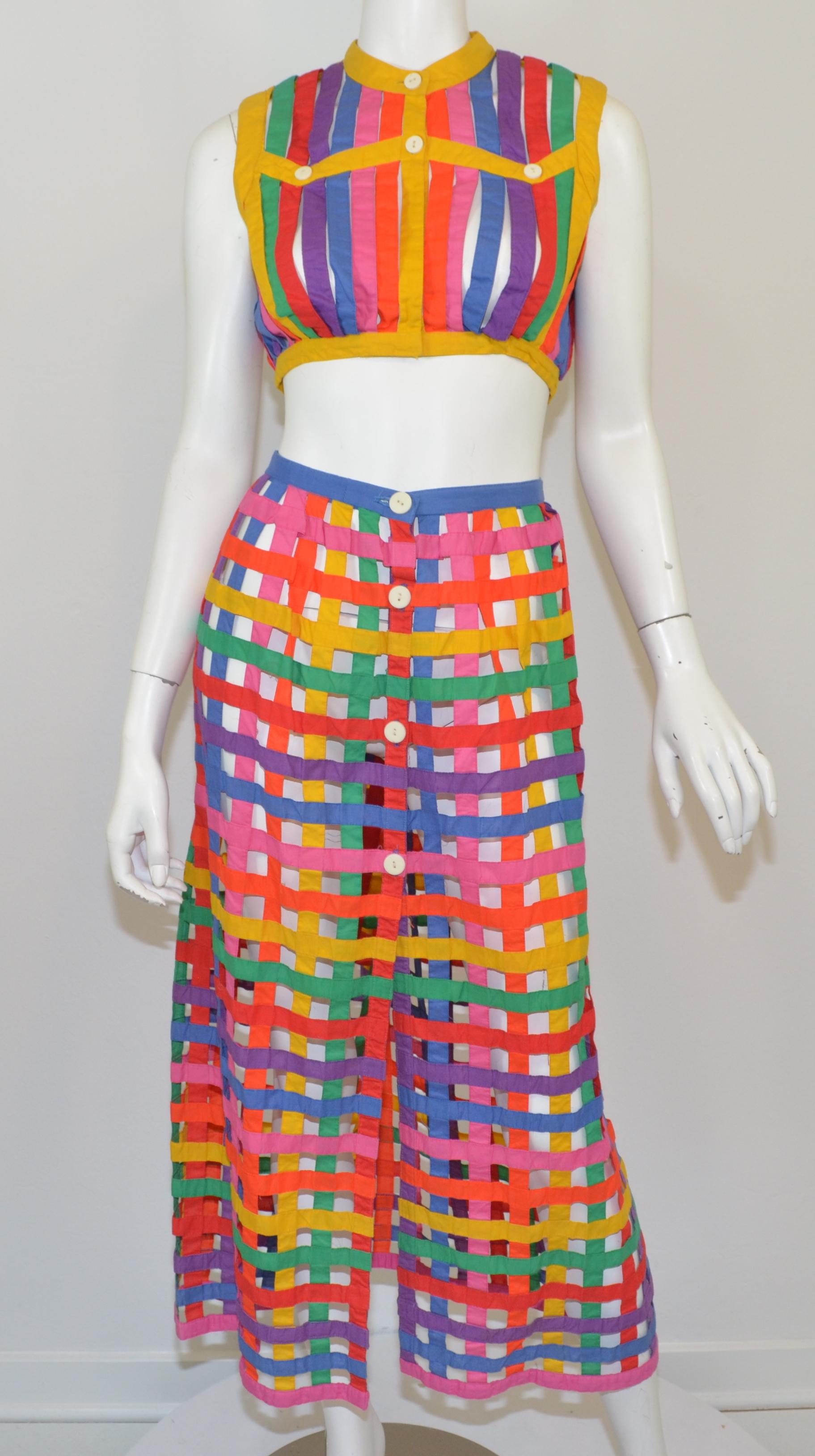 Vintage Bill Atkinson skirt set is featured in a multicolor caged design. Cropped top has button closures at the neck and a hook-and-eye fastening at the hem, and the skirt has button fastenings along the front. 

Measurements:
Top: bust 34”, waist