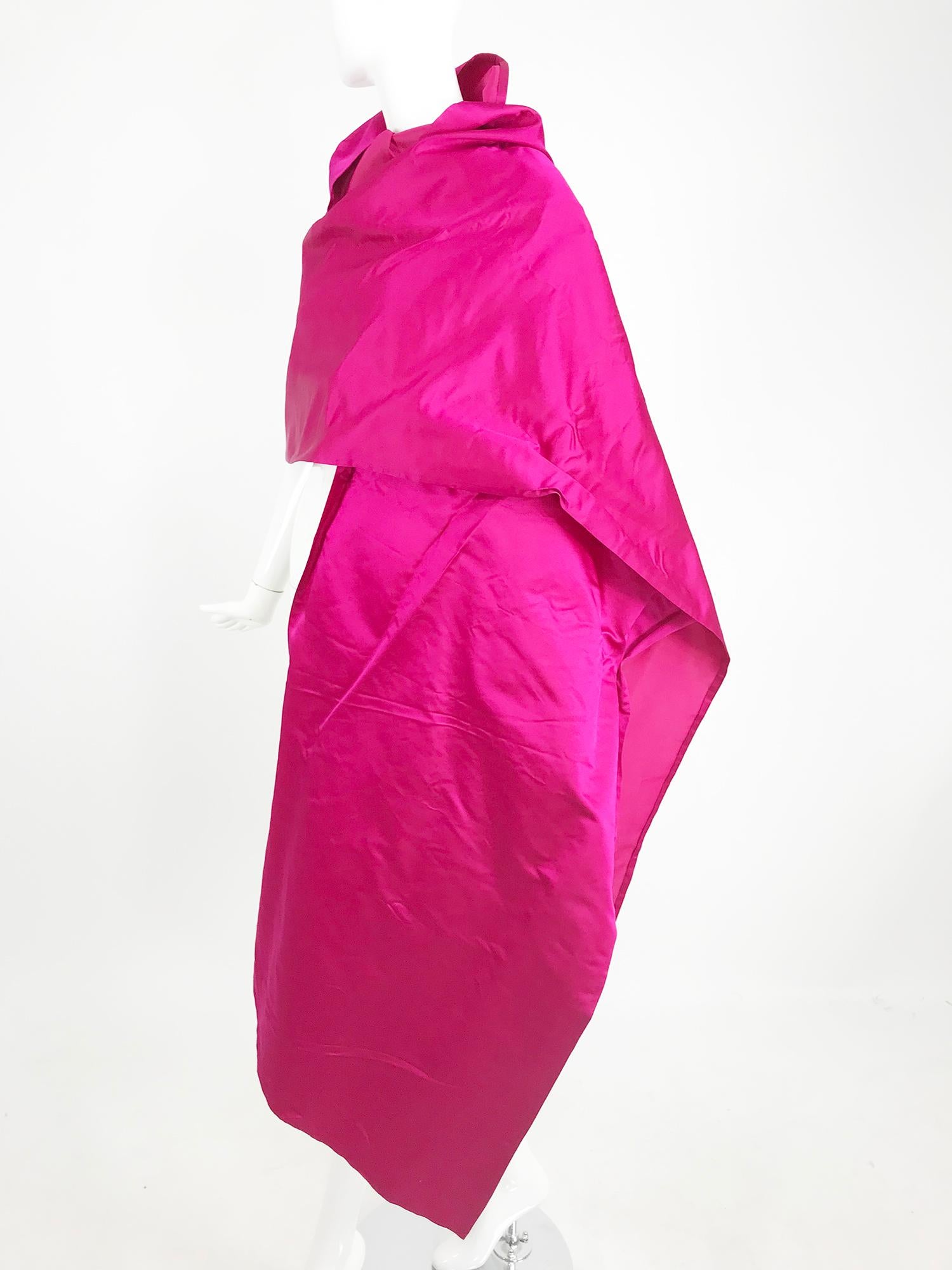 Bill Bass Fuchsia Silk Satin Evening Wrap from the 1970s. Gorgeous and large evening wrap of lustrous silk satin in a fuchsia/hot pink shade. The perfect addition to any big night gown. This has the original tag and is unworn, there is however a