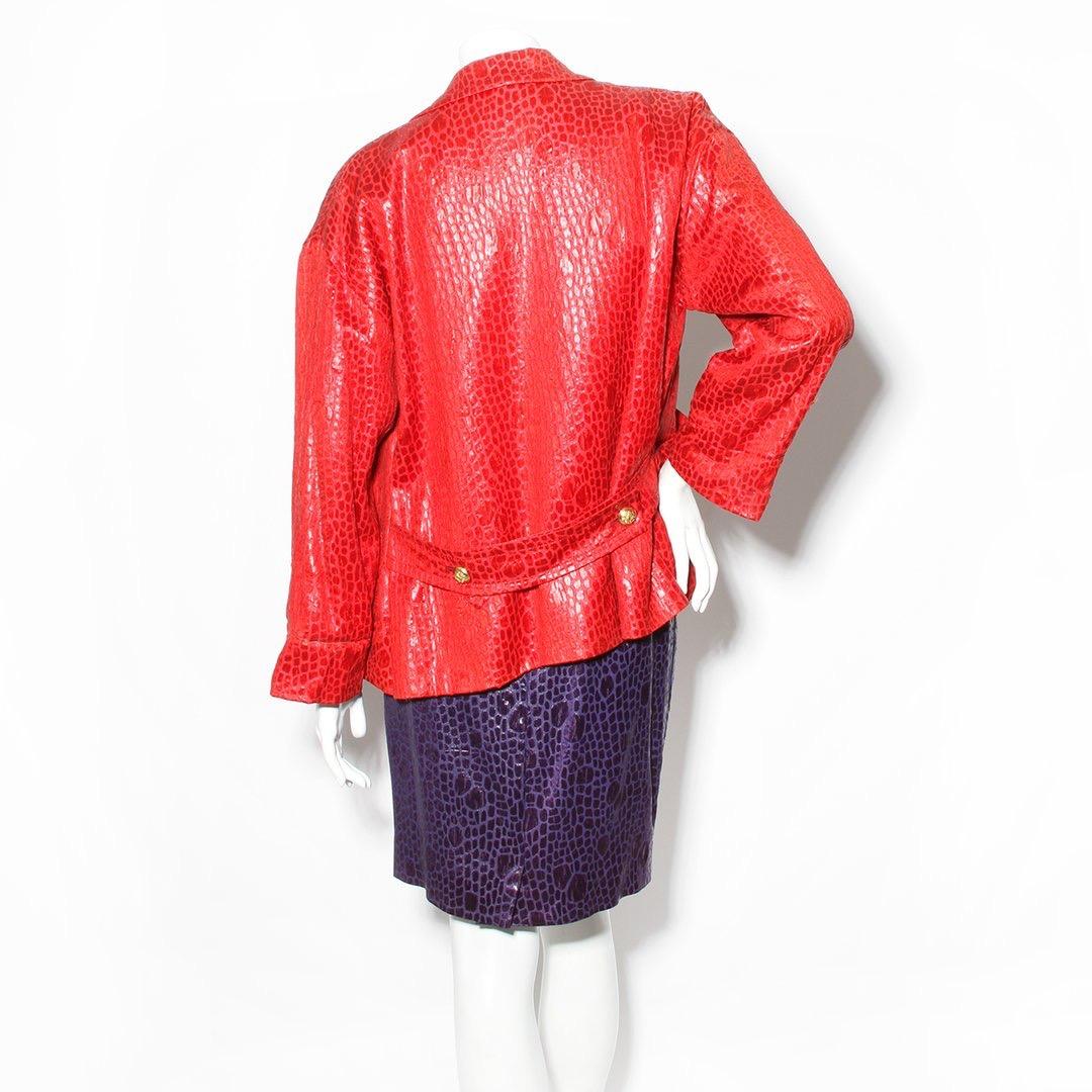 Product Details:
Animal print skirt suit by Bill Blass
Circa 1980s 
Red jacket 
Animal print 
Long Sleeve
Notched collar 
Two front pockets 
Back belt detail 
Open front 
Purple skirt 
Animal print
Flat front pleats 
Two side pockets 
High waist