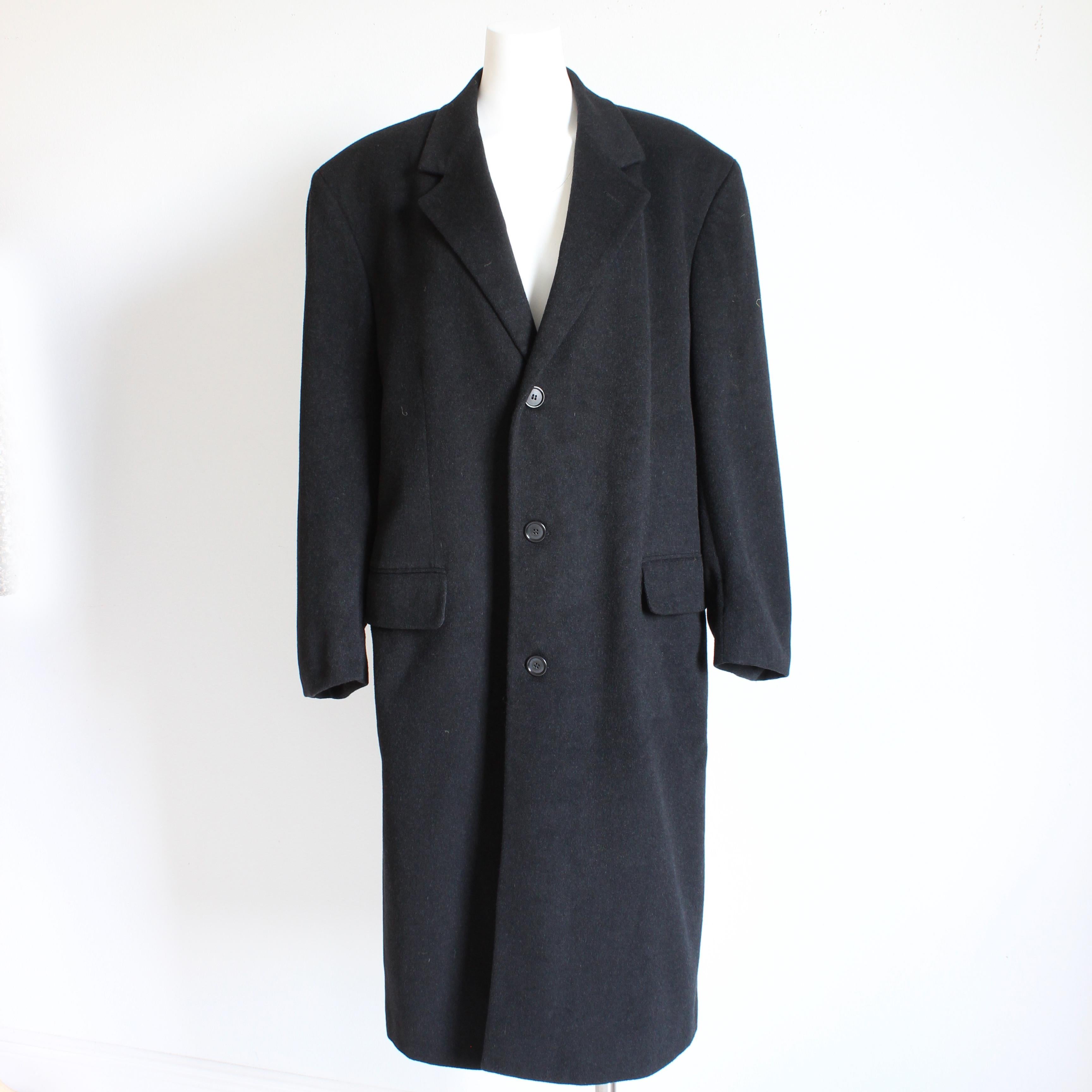 Authentic, preowned, vintage Bill Blass Black Label Cashmere Blend coat, likely made in the 90s. Made from a black cashmere wool blend, it features classic styling and construction with flap pockets at each hip.   Iconic styling and quality