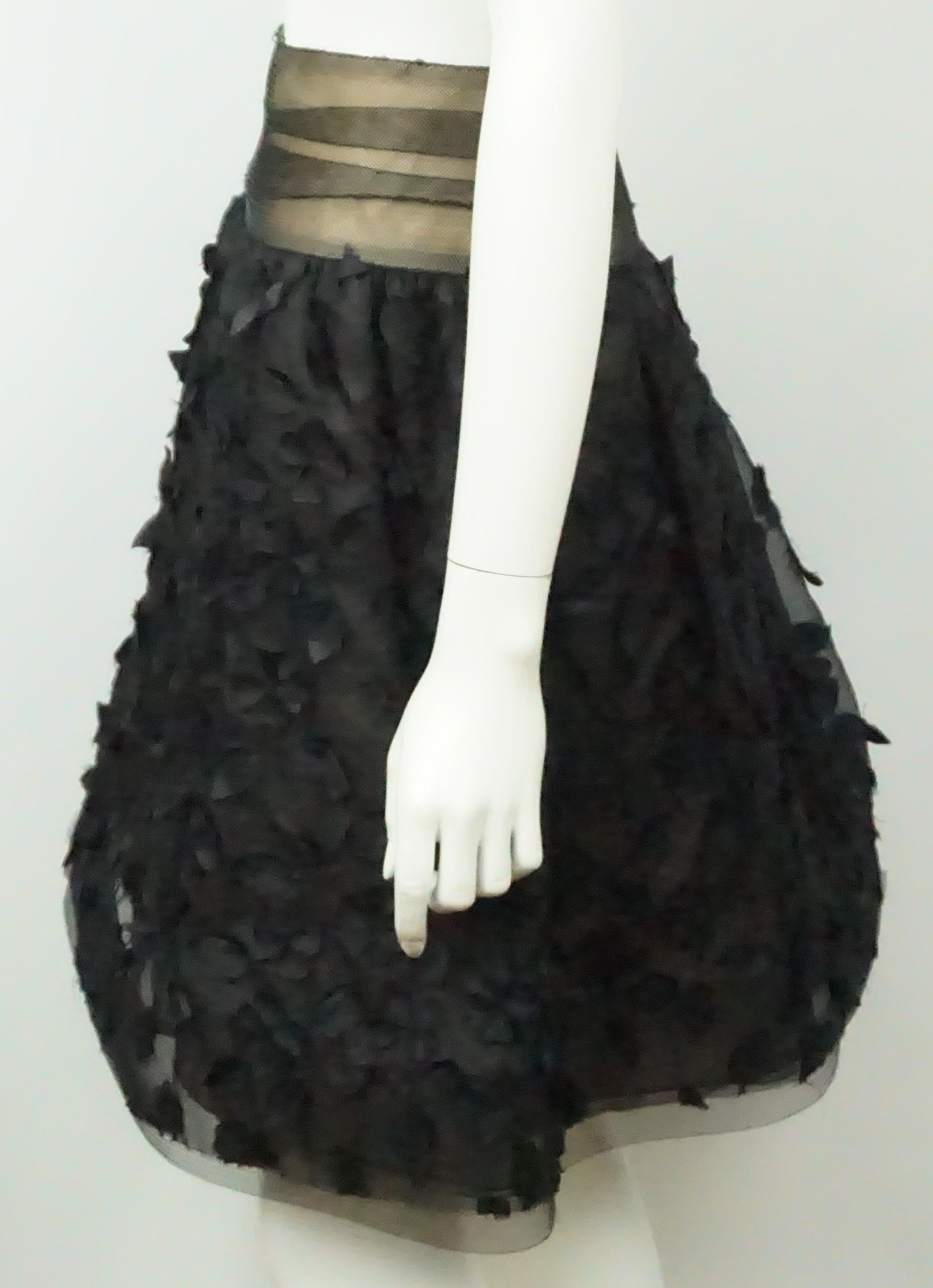 Beautiful, short black evening skirt with a 4'' wide hip to waist band made out of knit horsehair. From the hip to the bottom of the skirt is a very delicate and elegant carved out and embroidered small, black silk flowers on black silk backround.