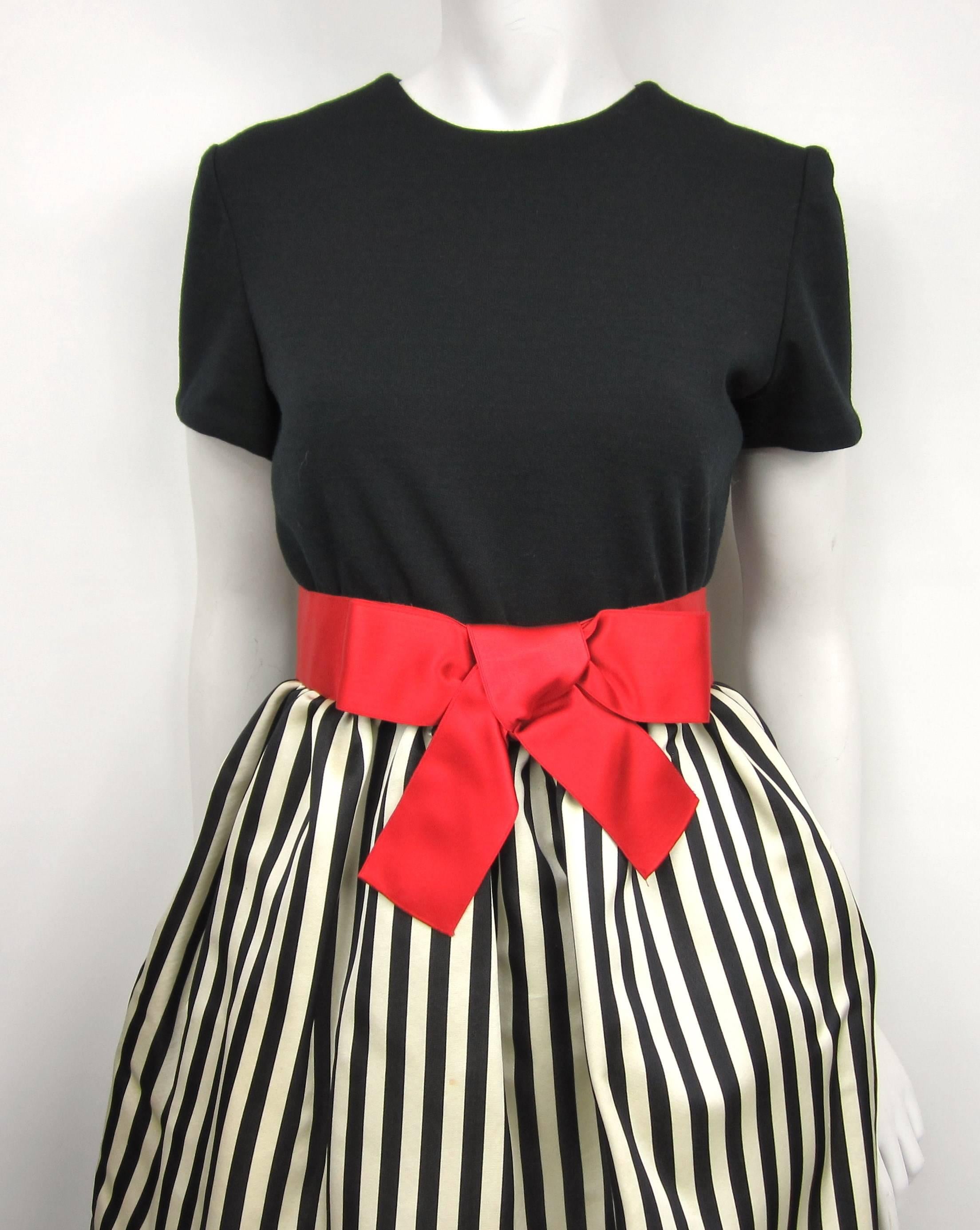 Fantastic Bill Blass dress. Featuring a crinoline under skirt with a Attached red silk bow belt. black bodice with zippered back. It has slit pockets in the skirt!! . Measuring Up to 36 inch bust----Up to 27 inch waist ---Hips open ---37.5 inch down