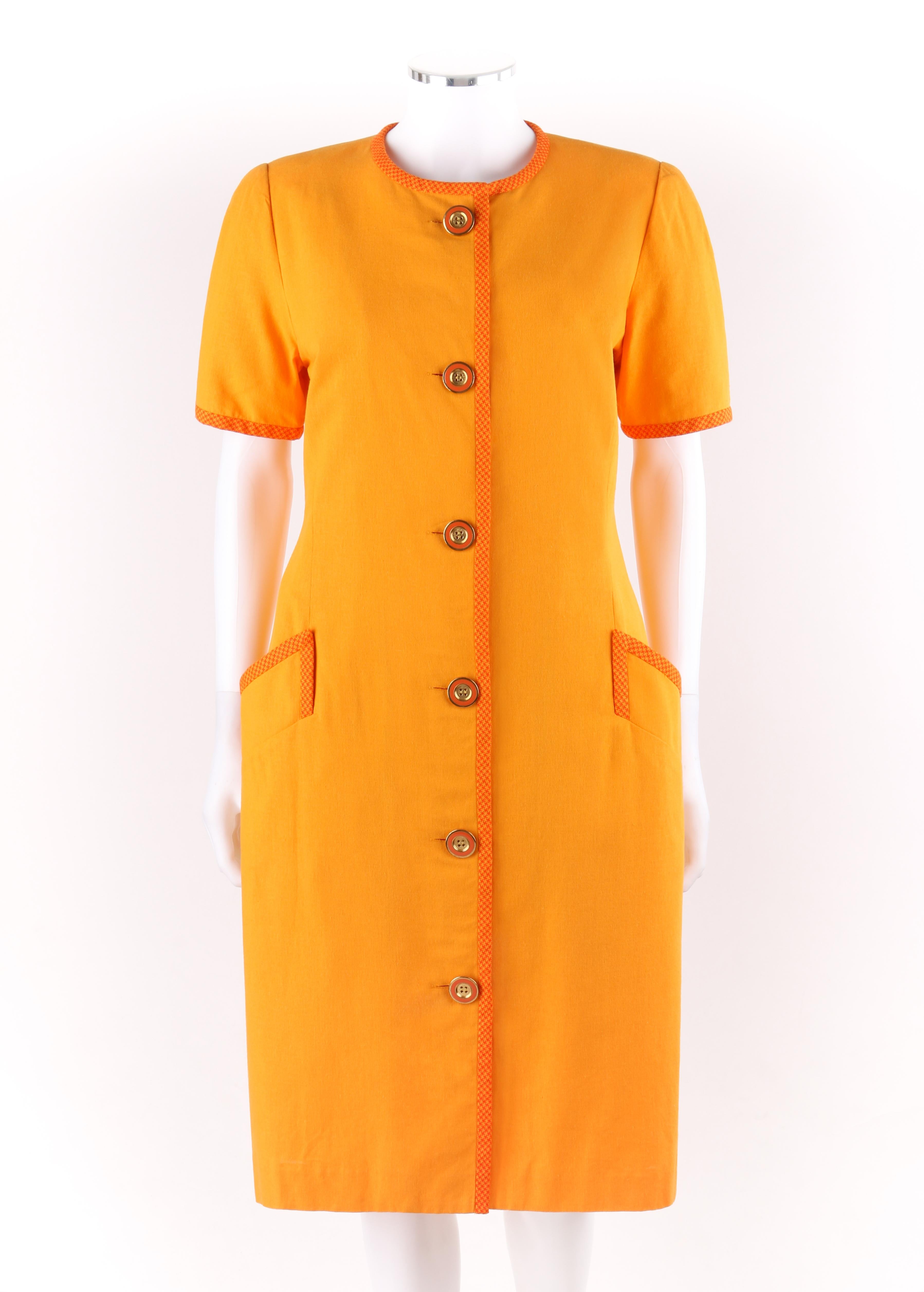 BILL BLASS c.1980’s Orange Houndstooth Trim Short Sleeve Button Up Day Dress

Circa: 1980’s 
Label(s): Bill Blass Dress
Designer: Bill Blass
Style: Sheath day dress
Color(s): Shades of orange  
Lined: Yes
Marked Fabric Content: “70% Rayon, 30%