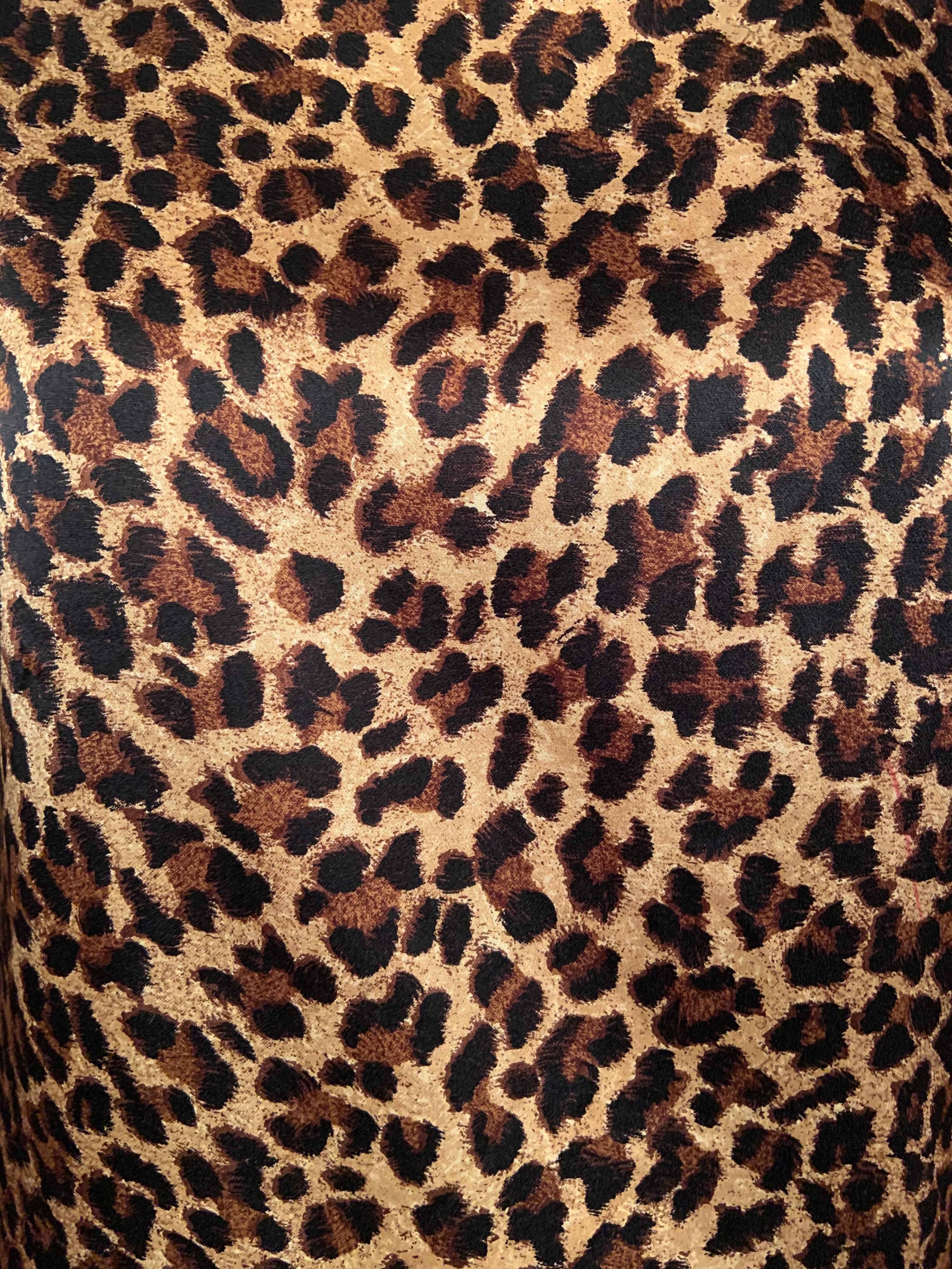 A gorgeous leopard print makes this classic style blouse a real standout. The blouse has a round neckline, long sleeves, a finished hem with slits on both sides and fabric covered buttons at the wrists and the center back. Retailed by Saks Fifth