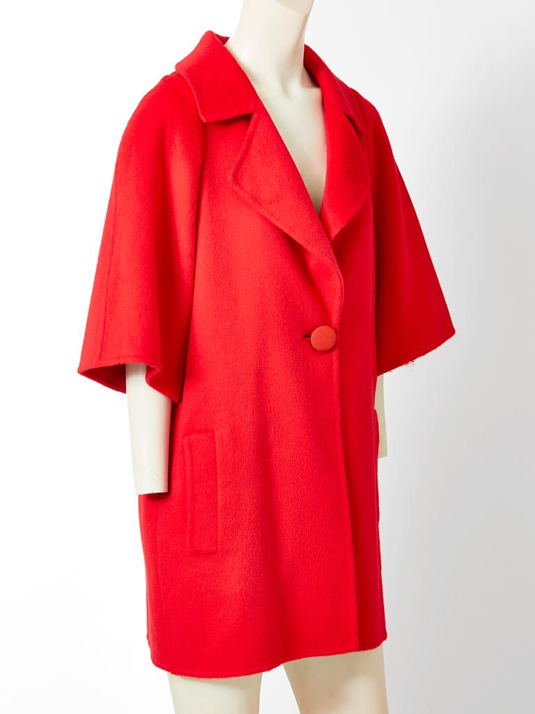 Bill Blass, red, double face, cashmere, coat having 3/4 sleeves, a notched collar, a single button closure  and back smocking detail. 