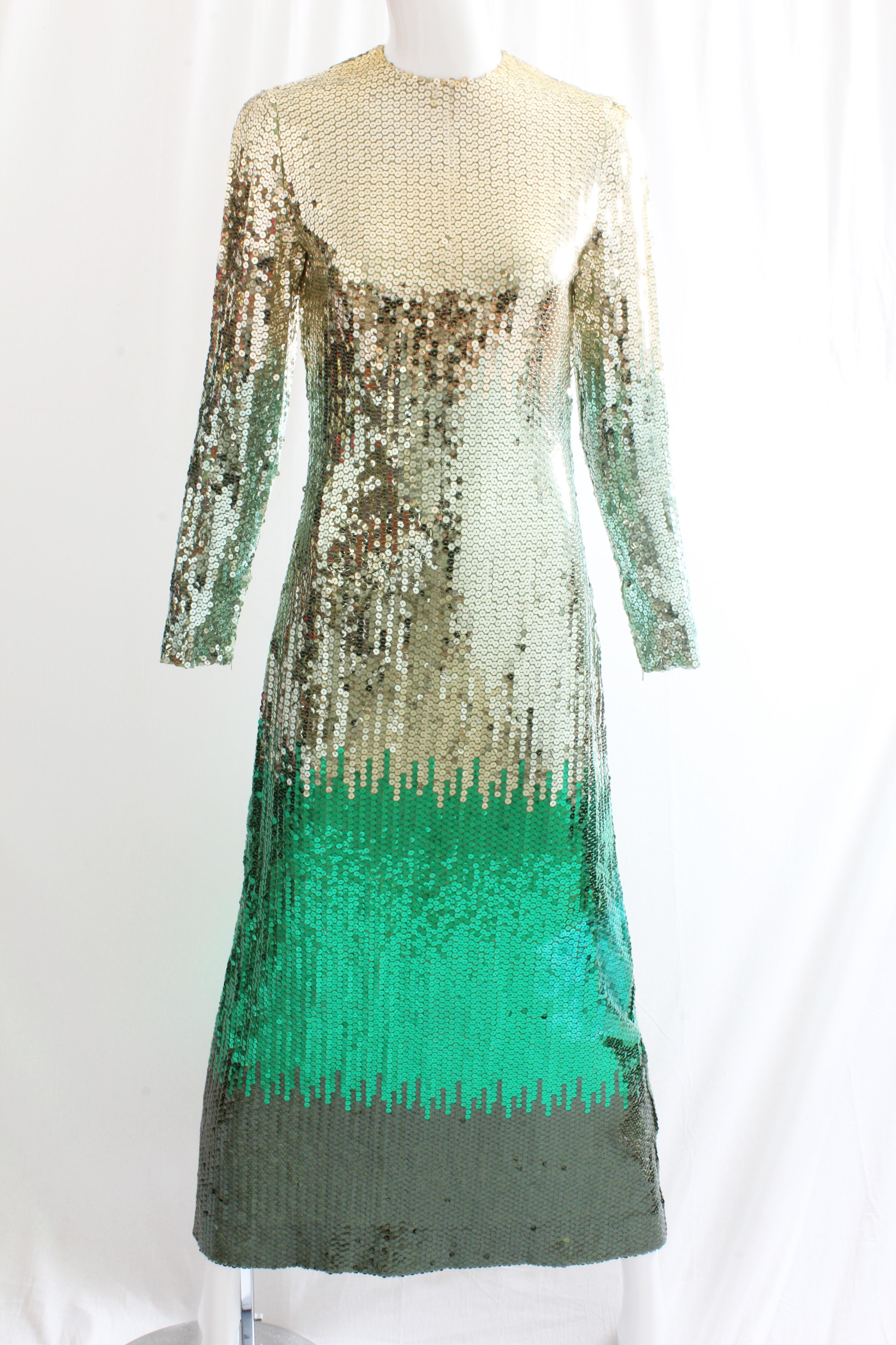 This sparkling evening gown was designed by Bill Blass, most likely in the 1970s, and is made from literally thousands of metallic sequins. Designed with an ombre effect, the top portion is silver and transitions to a metallic emerald on the skirt