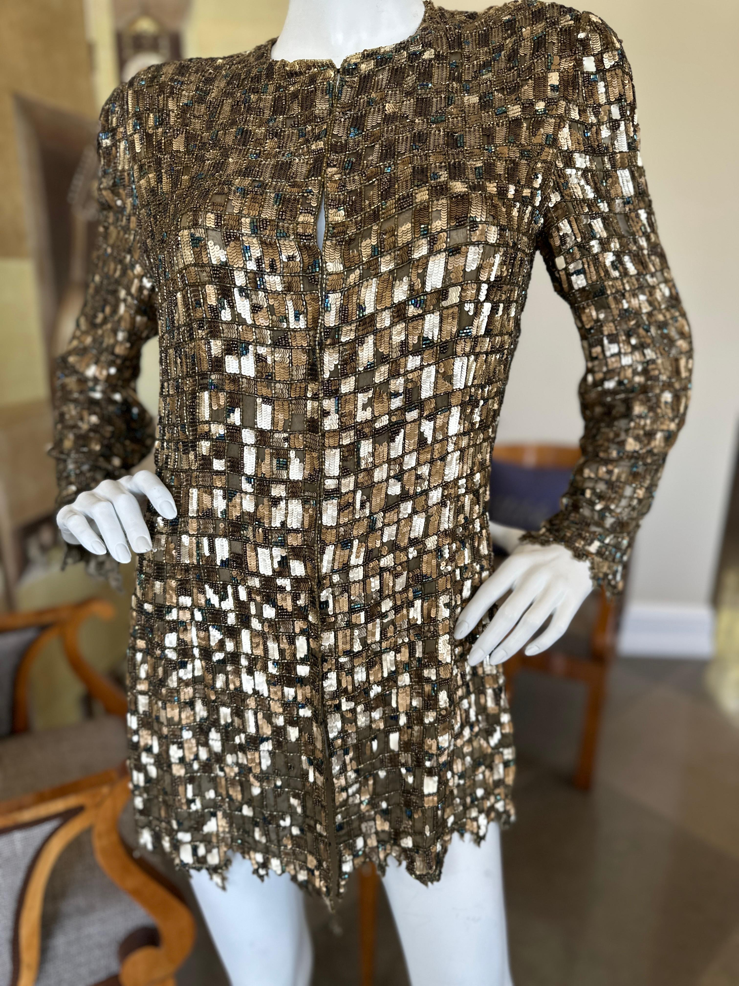 This very special Bill Blass evening jacket is covered in a mosiac pattern with gold and copper sequins, and blue aurora borealis and copper bugle beads. The unusual geometric pattern and matte sequins lend the piece an innate sophistication that is