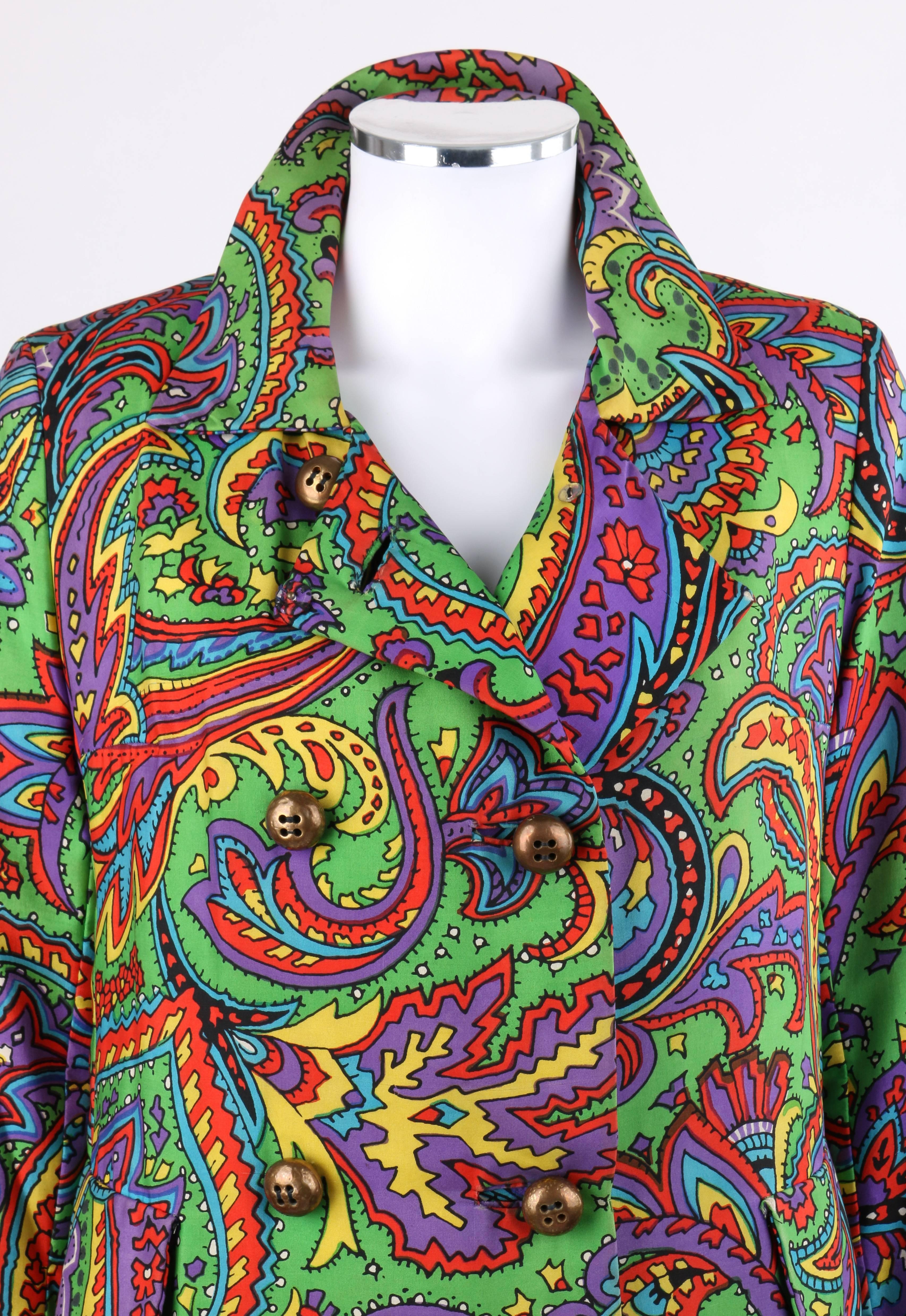 Vintage Bill Blass for Bond Street c.1970's multi-color paisley print double breasted coat. Bold multi-color paisley print in shades of red, yellow, purple, blue, black, and white on green. Bal collar. Long sleeves. Six gold-toned metal double