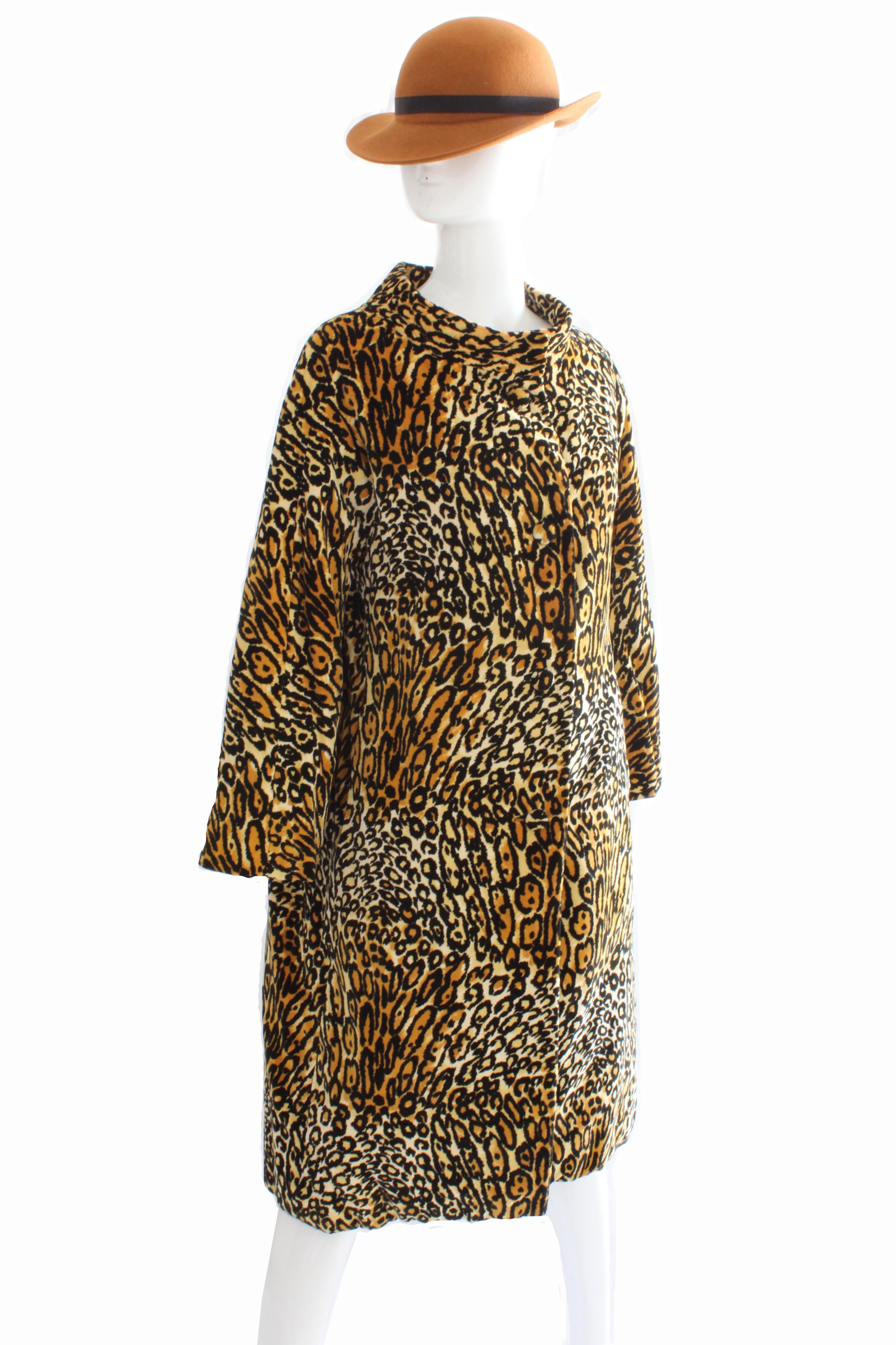 This fabulous coat was made by Bill Blass for Bond Street, most likely in the early 1970s. Made from velvet, it features a leopard print throughout and fastens from the collar to the hips. Lined in leopard print velvet at the bodice, with the