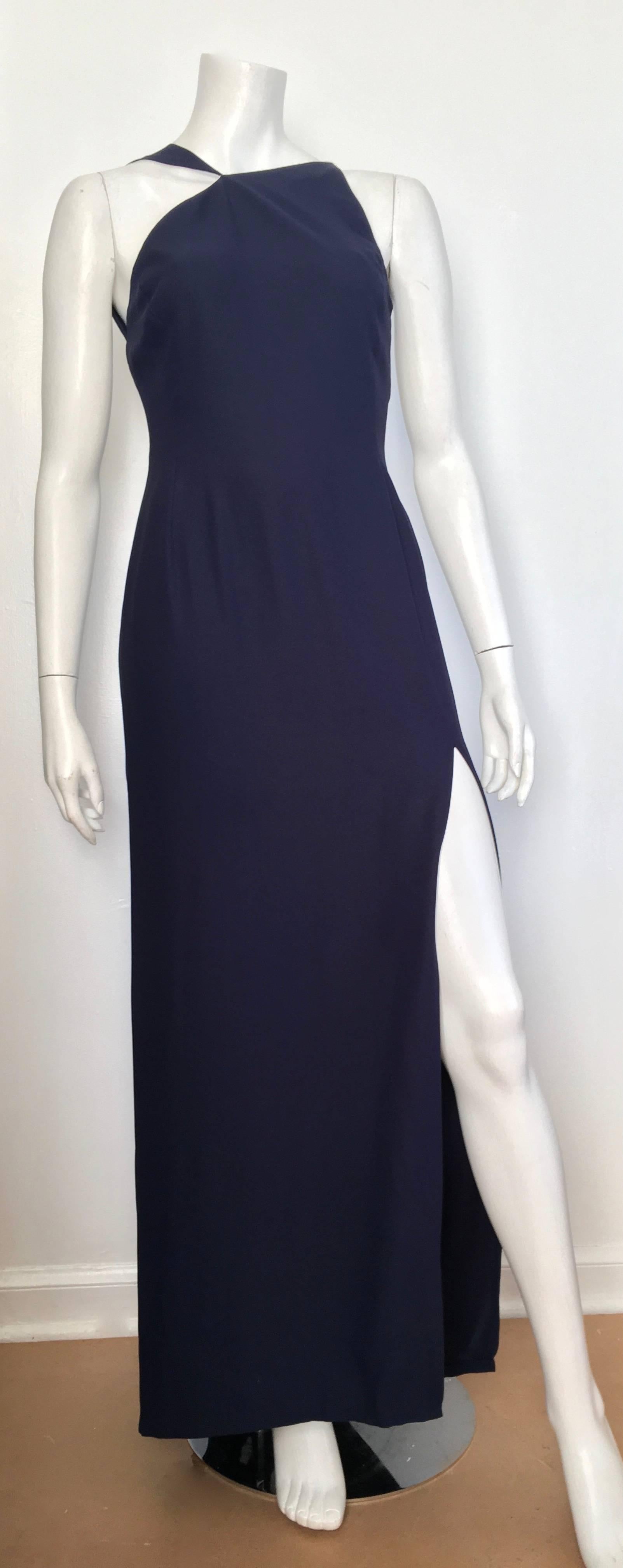 Bill Blass for Neiman Marcus 1980s navy silk crepe flowing sleeveless gown with train is labeled a size 8 but fits more like a modern size 6.  The waist on this dress is 28. 1/2