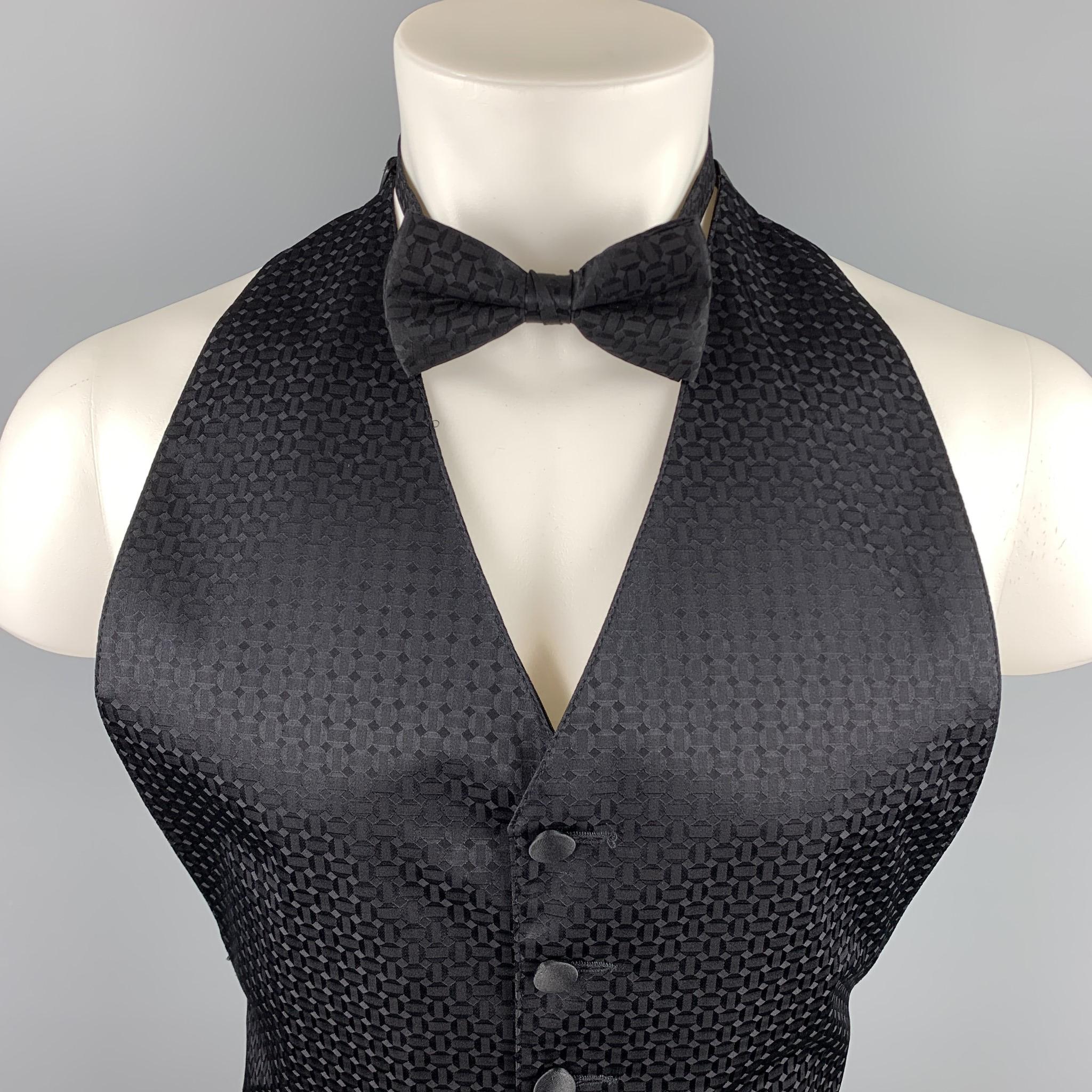 BILL BLASS vest set comes in a black on black geometric print featuring a match bow tie set, slit pockets, and a buttoned closure. 

Good Pre-Owned Condition.
Marked: No size marked 

Measurements:

Shoulder: 10.5 in. 
Length: 25 in. 

SKU: