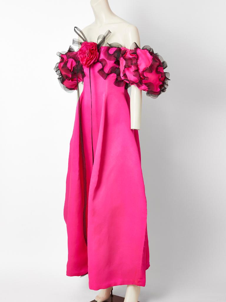 Bill Blass, fuchsia, multi layered, organza, off the shoulder gown, having a sculptural silhouette with a fitted bodice. Sleeves have a bouffant shape held up by elastic with black horsehair decorative trim. 
Single poppy flower at the center bust. 