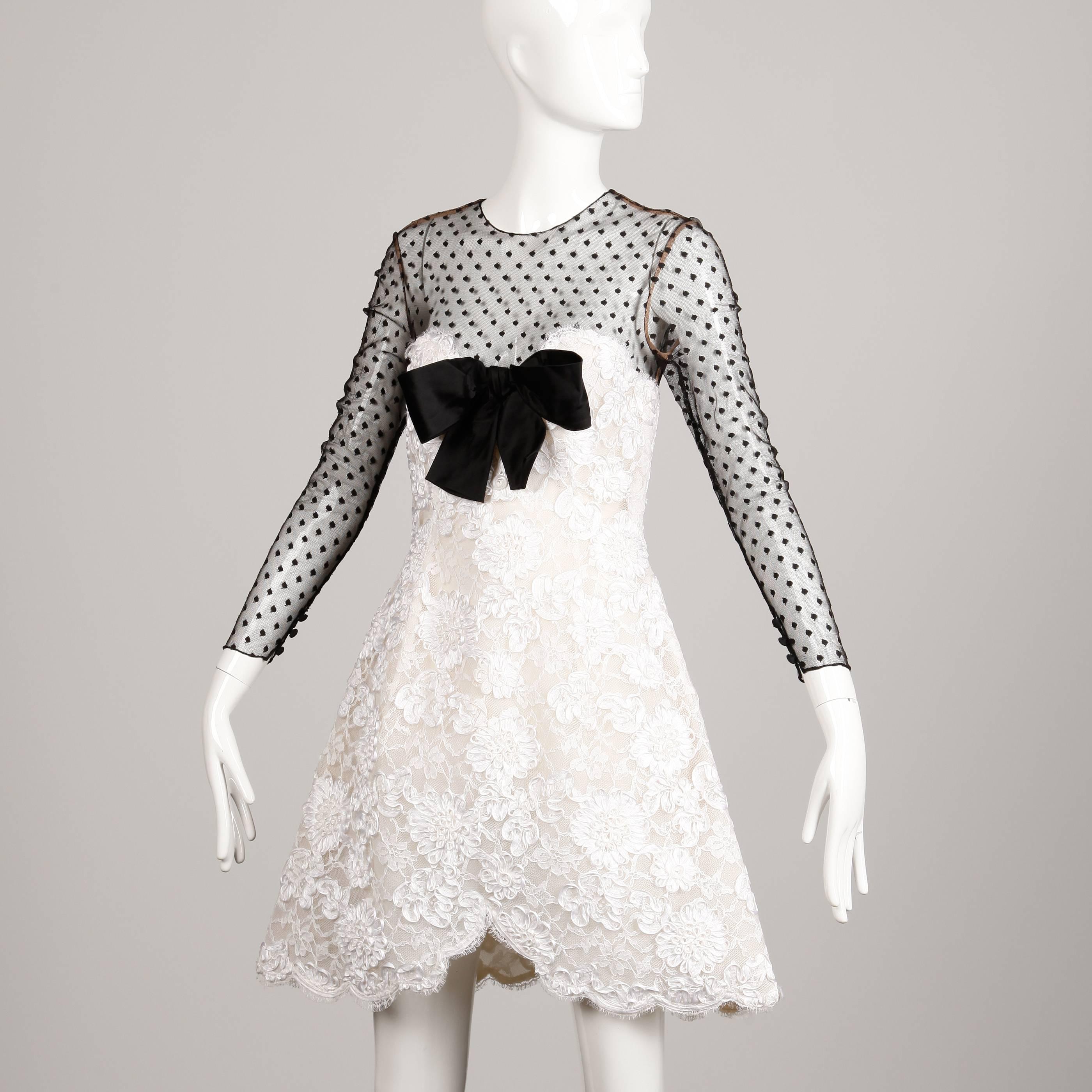 Darling black and white cocktail dress by Bill Blass. Sweetheart neckline and scalloped hem. Mesh sleeves and black silk bow detail at the bust. Fits like a modern size small. Bust: 34