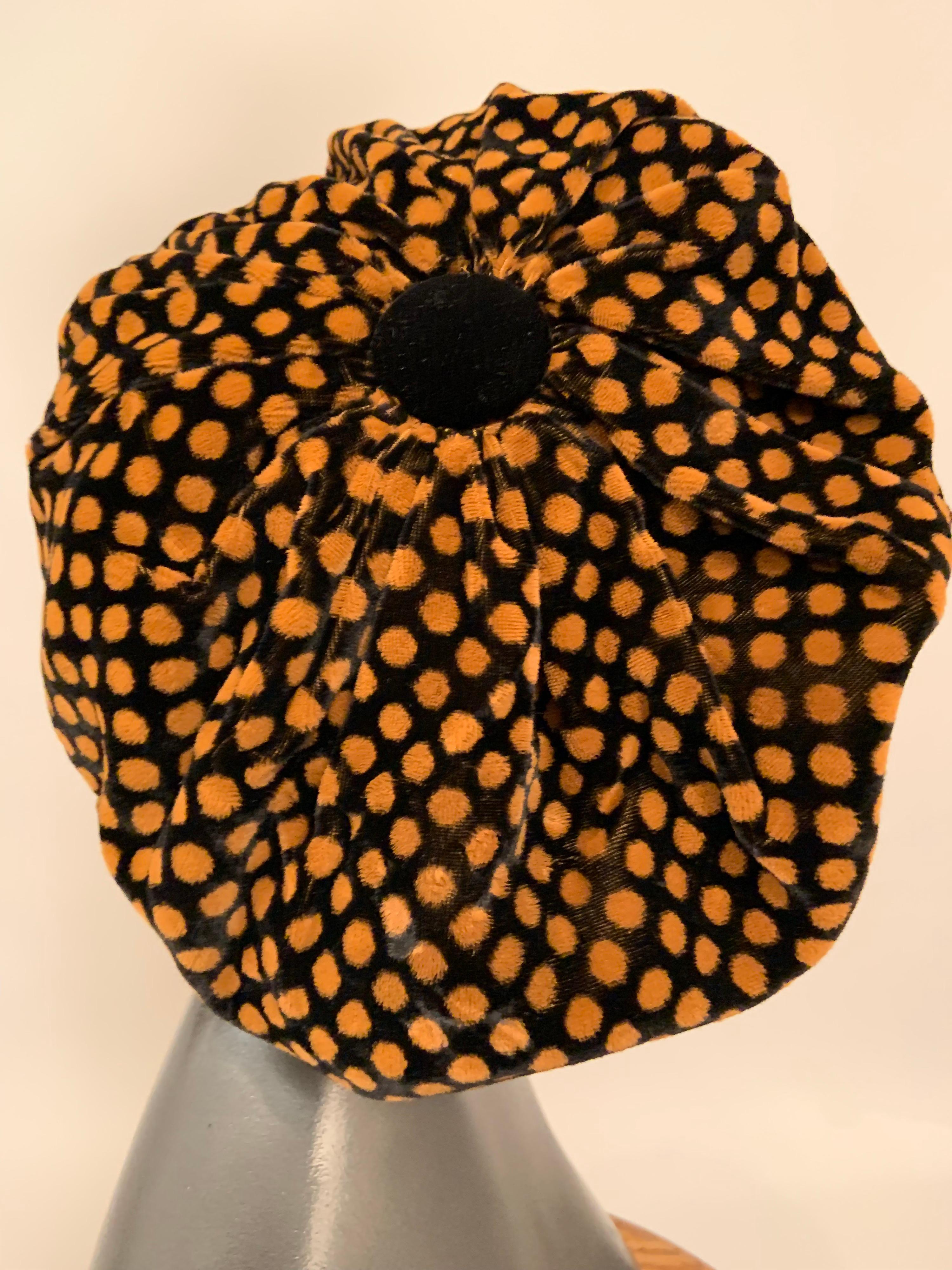 Famed New York Times photographer Bill Cunningham designed hats before He picked up his camera. This soft black velvet hat with mocha colored polka dots drapes over the black velvet brim of this oversized newsboy cap. A large black velvet button top