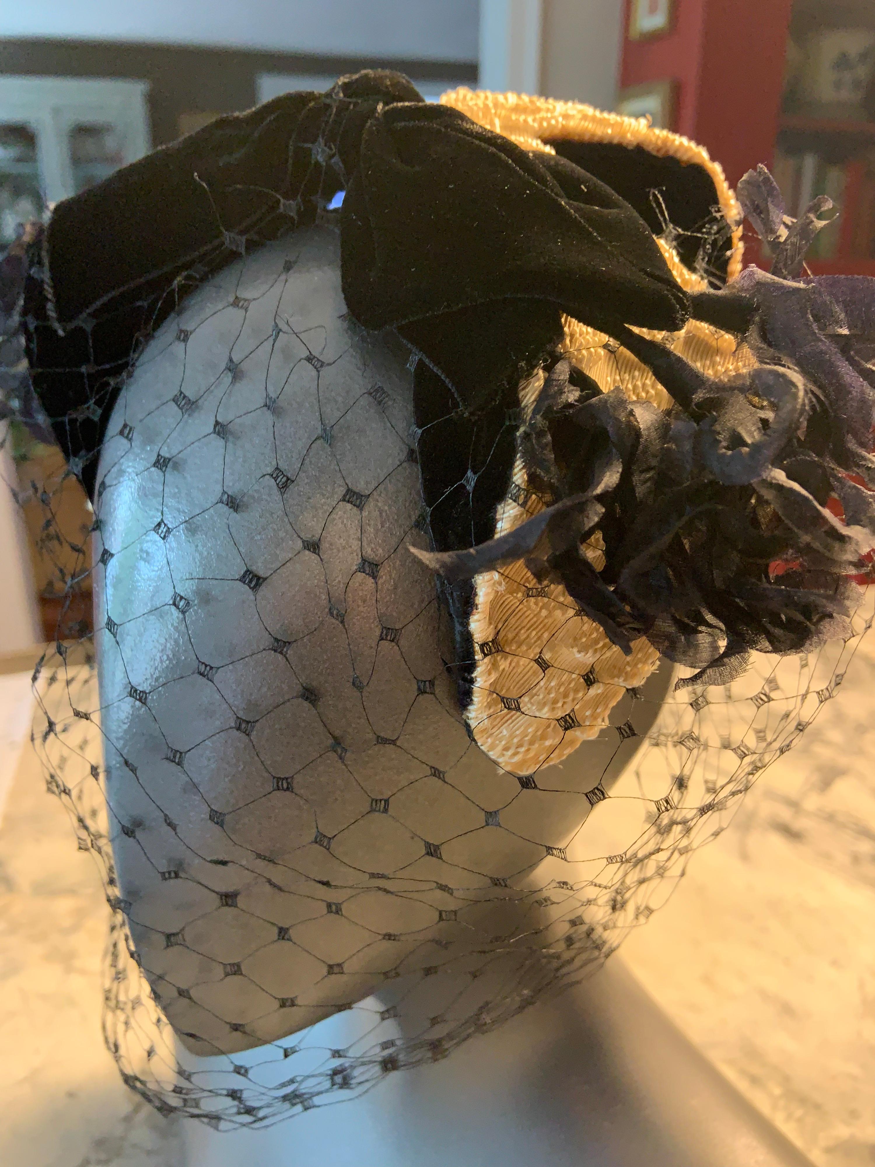 Silk organza flowers, black velvet, point d'esprit veiling and a novelty silk faille  fabric are all used to create this cocktail hat designed by Bill Cunningham before he became famous as a New York Times photographer. The hat is in excellent
